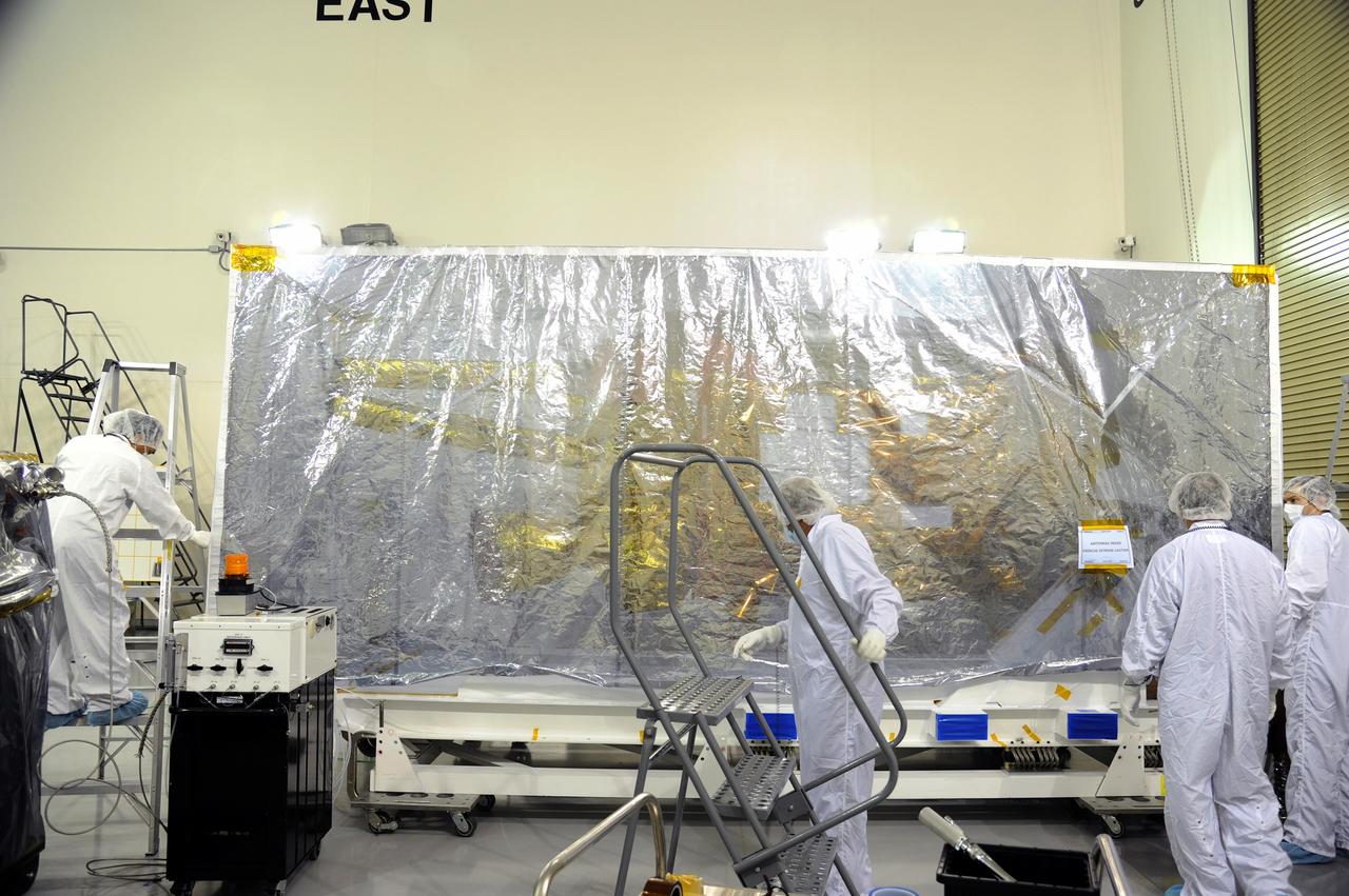 VANDENBERG AIR FORCE BASE, Calif. – The protective covering has been replaced around NASA's Soil Moisture Active Passive, or SMAP, spacecraft following the spacecraft's post-shipment inspection in the Astrotech payload processing facility on Vandenberg Air Force Base in California. The covering will protect the spacecraft from static-charge buildup and contamination while it awaits further processing.    SMAP will launch on a Delta II 7320 configuration vehicle featuring a United Launch Alliance first stage booster powered by an Aerojet Rocketdyne RS-27A main engine and three Alliant Techsystems, or ATK, strap-on solid rocket motors. Once on station in Earth orbit, SMAP will provide global measurements of soil moisture and its freeze/thaw state. These measurements will be used to enhance understanding of processes that link the water, energy and carbon cycles, and to extend the capabilities of weather and climate prediction models. SMAP data also will be used to quantify net carbon flux in boreal landscapes and to develop improved flood prediction and drought monitoring capabilities. Launch from Space Launch Complex 2 is targeted for Jan. 29, 2015. To learn more about SMAP, visit http://smap.jpl.nasa.gov.  Photo credit: NASA/Robert Rasmison