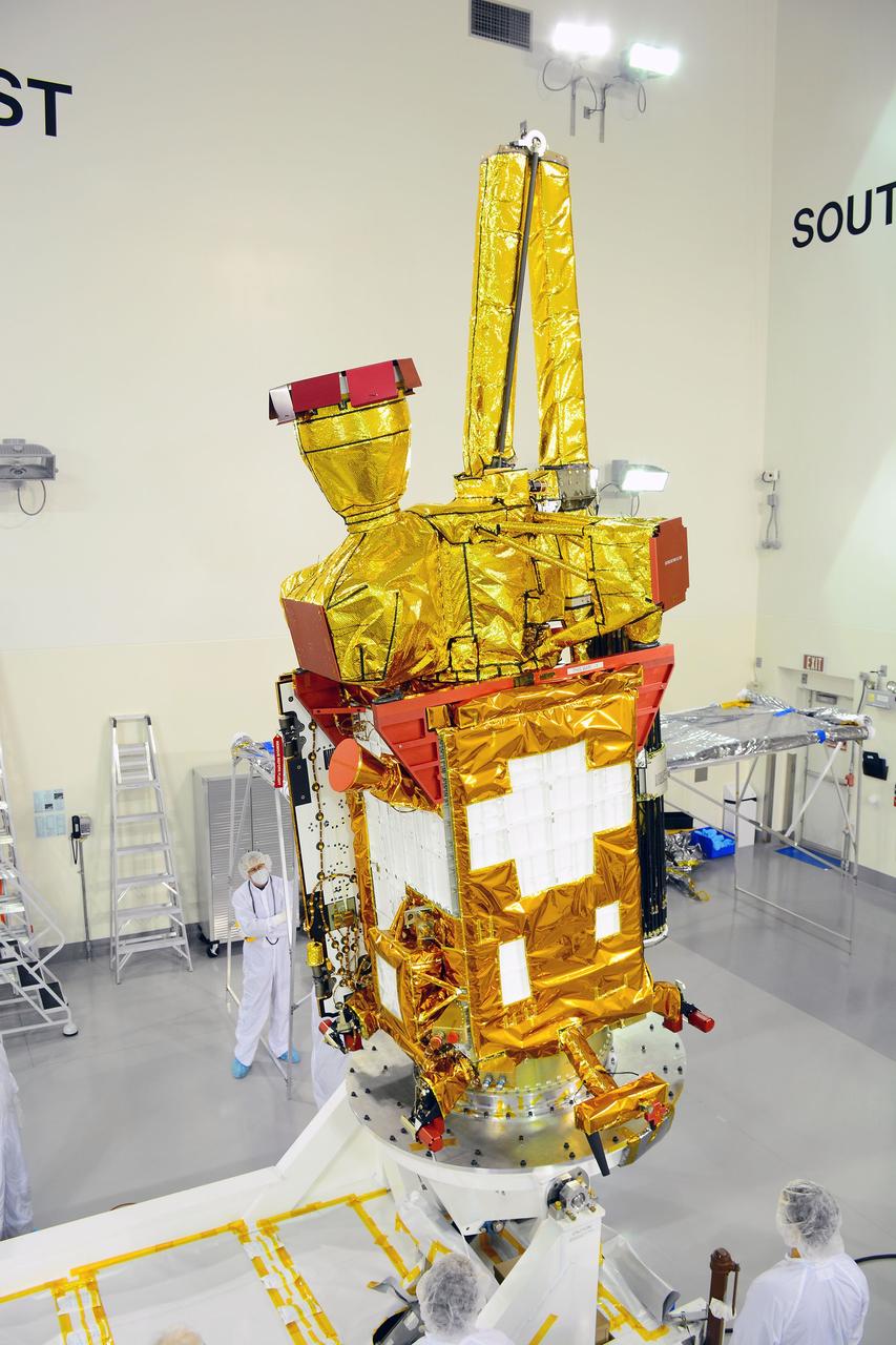 VANDENBERG AIR FORCE BASE, Calif. – Inside the Astrotech payload processing facility on Vandenberg Air Force Base in California, engineers and technicians rotate NASA's Soil Moisture Active Passive, or SMAP, spacecraft to begin processing.    SMAP will launch on a Delta II 7320 configuration vehicle featuring a United Launch Alliance first stage booster powered by an Aerojet Rocketdyne RS-27A main engine and three Alliant Techsystems, or ATK, strap-on solid rocket motors. Once on station in Earth orbit, SMAP will provide global measurements of soil moisture and its freeze/thaw state. These measurements will be used to enhance understanding of processes that link the water, energy and carbon cycles, and to extend the capabilities of weather and climate prediction models. SMAP data also will be used to quantify net carbon flux in boreal landscapes and to develop improved flood prediction and drought monitoring capabilities. Launch from Space Launch Complex 2 is targeted for Jan. 29, 2015. To learn more about SMAP, visit http://smap.jpl.nasa.gov Photo credit: NASA/ Randy Beaudoin