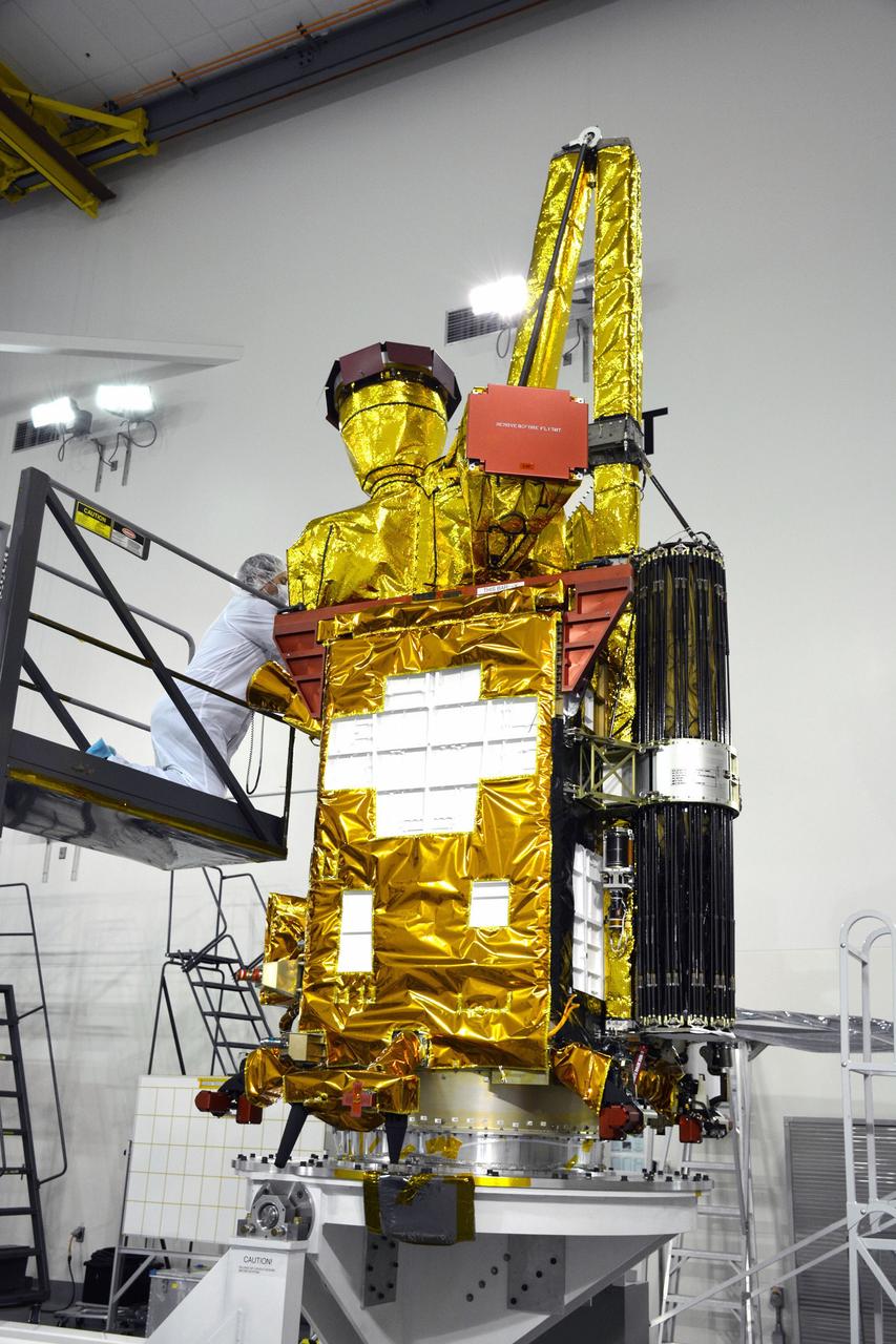 VANDENBERG AIR FORCE BASE, Calif. – Inside the Astrotech payload processing facility on Vandenberg Air Force Base in California, engineers and technicians have rotated NASA's Soil Moisture Active Passive, or SMAP, spacecraft to begin processing.    SMAP will launch on a Delta II 7320 configuration vehicle featuring a United Launch Alliance first stage booster powered by an Aerojet Rocketdyne RS-27A main engine and three Alliant Techsystems, or ATK, strap-on solid rocket motors. Once on station in Earth orbit, SMAP will provide global measurements of soil moisture and its freeze/thaw state. These measurements will be used to enhance understanding of processes that link the water, energy and carbon cycles, and to extend the capabilities of weather and climate prediction models. SMAP data also will be used to quantify net carbon flux in boreal landscapes and to develop improved flood prediction and drought monitoring capabilities. Launch from Space Launch Complex 2 is targeted for Jan. 29, 2015. To learn more about SMAP, visit http://smap.jpl.nasa.gov Photo credit: NASA/ Randy Beaudoin