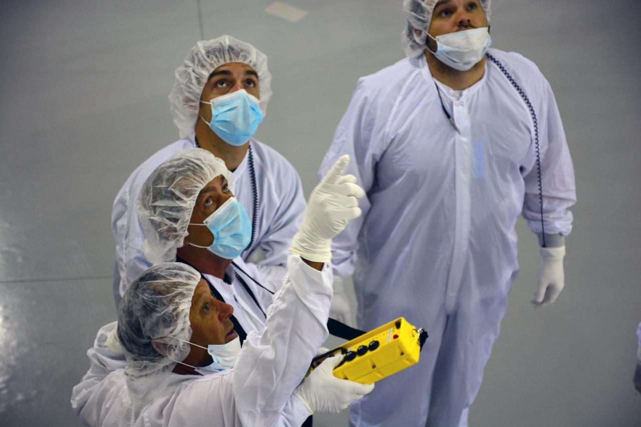 VANDENBERG AIR FORCE BASE, Calif. – Inside the Astrotech payload processing facility on Vandenberg Air Force Base in California, engineers and technicians wearing protective garb, monitor operations as a crane lifts a component of NASA's Soil Moisture Active Passive, or SMAP, spacecraft.    SMAP will launch on a Delta II 7320 configuration vehicle featuring a United Launch Alliance first stage booster powered by an Aerojet Rocketdyne RS-27A main engine and three Alliant Techsystems, or ATK, strap-on solid rocket motors. Once on station in Earth orbit, SMAP will provide global measurements of soil moisture and its freeze/thaw state. These measurements will be used to enhance understanding of processes that link the water, energy and carbon cycles, and to extend the capabilities of weather and climate prediction models. SMAP data also will be used to quantify net carbon flux in boreal landscapes and to develop improved flood prediction and drought monitoring capabilities. Launch from Space Launch Complex 2 is targeted for Jan. 29, 2015. To learn more about SMAP, visit http://smap.jpl.nasa.gov Photo credit: NASA/ Randy Beaudoin