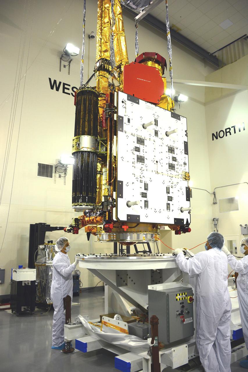 VANDENBERG AIR FORCE BASE, Calif. – Inside the Astrotech payload processing facility on Vandenberg Air Force Base in California, engineers and technicians inspect NASA's Soil Moisture Active Passive, or SMAP, spacecraft.    SMAP will launch on a Delta II 7320 configuration vehicle featuring a United Launch Alliance first stage booster powered by an Aerojet Rocketdyne RS-27A main engine and three Alliant Techsystems, or ATK, strap-on solid rocket motors. Once on station in Earth orbit, SMAP will provide global measurements of soil moisture and its freeze/thaw state. These measurements will be used to enhance understanding of processes that link the water, energy and carbon cycles, and to extend the capabilities of weather and climate prediction models. SMAP data also will be used to quantify net carbon flux in boreal landscapes and to develop improved flood prediction and drought monitoring capabilities. Launch from Space Launch Complex 2 is targeted for Jan. 29, 2015. To learn more about SMAP, visit http://smap.jpl.nasa.gov Photo credit: NASA/ Randy Beaudoin