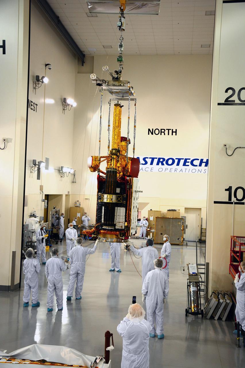 VANDENBERG AIR FORCE BASE, Calif. – Inside the Astrotech payload processing facility on Vandenberg Air Force Base in California, engineers and technicians use a crane to move NASA's Soil Moisture Active Passive, or SMAP, spacecraft.      SMAP will launch on a Delta II 7320 configuration vehicle featuring a United Launch Alliance first stage booster powered by an Aerojet Rocketdyne RS-27A main engine and three Alliant Techsystems, or ATK, strap-on solid rocket motors. Once on station in Earth orbit, SMAP will provide global measurements of soil moisture and its freeze/thaw state. These measurements will be used to enhance understanding of processes that link the water, energy and carbon cycles, and to extend the capabilities of weather and climate prediction models. SMAP data also will be used to quantify net carbon flux in boreal landscapes and to develop improved flood prediction and drought monitoring capabilities. Launch from Space Launch Complex 2 is targeted for Jan. 29, 2015. To learn more about SMAP, visit http://smap.jpl.nasa.gov Photo credit: NASA/ Randy Beaudoin