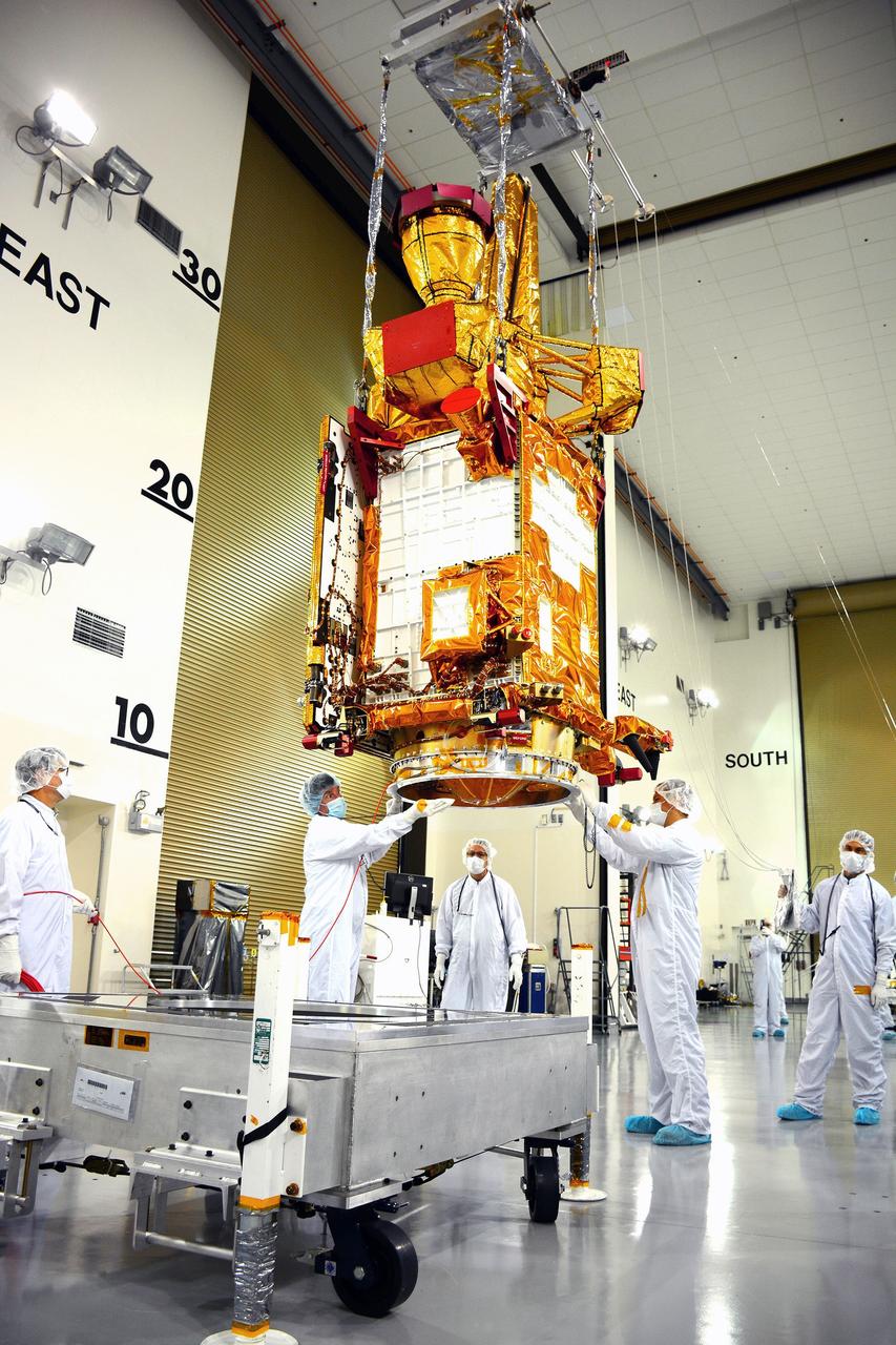 VANDENBERG AIR FORCE BASE, Calif. – Inside the Astrotech payload processing facility on Vandenberg Air Force Base in California, engineers and technicians use a crane to move NASA's Soil Moisture Active Passive, or SMAP, spacecraft.    SMAP will launch on a Delta II 7320 configuration vehicle featuring a United Launch Alliance first stage booster powered by an Aerojet Rocketdyne RS-27A main engine and three Alliant Techsystems, or ATK, strap-on solid rocket motors. Once on station in Earth orbit, SMAP will provide global measurements of soil moisture and its freeze/thaw state. These measurements will be used to enhance understanding of processes that link the water, energy and carbon cycles, and to extend the capabilities of weather and climate prediction models. SMAP data also will be used to quantify net carbon flux in boreal landscapes and to develop improved flood prediction and drought monitoring capabilities. Launch from Space Launch Complex 2 is targeted for Jan. 29, 2015. To learn more about SMAP, visit http://smap.jpl.nasa.gov Photo credit: NASA/ Randy Beaudoin