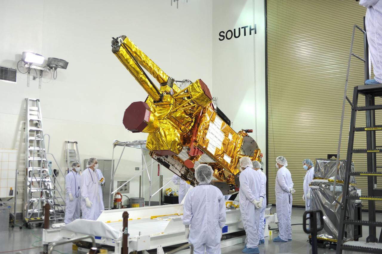 VANDENBERG AIR FORCE BASE, Calif. – Inside the Astrotech payload processing facility on Vandenberg Air Force Base in California, engineers and technicians rotate NASA's Soil Moisture Active Passive, or SMAP, spacecraft to begin processing.      SMAP will launch on a Delta II 7320 configuration vehicle featuring a United Launch Alliance first stage booster powered by an Aerojet Rocketdyne RS-27A main engine and three Alliant Techsystems, or ATK, strap-on solid rocket motors. Once on station in Earth orbit, SMAP will provide global measurements of soil moisture and its freeze/thaw state. These measurements will be used to enhance understanding of processes that link the water, energy and carbon cycles, and to extend the capabilities of weather and climate prediction models. SMAP data also will be used to quantify net carbon flux in boreal landscapes and to develop improved flood prediction and drought monitoring capabilities. Launch from Space Launch Complex 2 is targeted for Jan. 29, 2015. To learn more about SMAP, visit http://smap.jpl.nasa.gov Photo credit: NASA/ Robert Rasmison