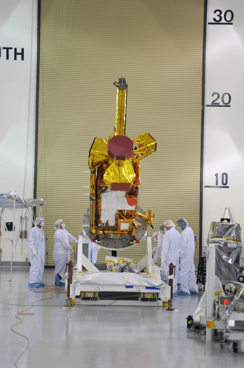 VANDENBERG AIR FORCE BASE, Calif. – Inside the Astrotech payload processing facility on Vandenberg Air Force Base in California, engineers and technicians rotate NASA's Soil Moisture Active Passive, or SMAP, spacecraft to begin processing.      SMAP will launch on a Delta II 7320 configuration vehicle featuring a United Launch Alliance first stage booster powered by an Aerojet Rocketdyne RS-27A main engine and three Alliant Techsystems, or ATK, strap-on solid rocket motors. Once on station in Earth orbit, SMAP will provide global measurements of soil moisture and its freeze/thaw state. These measurements will be used to enhance understanding of processes that link the water, energy and carbon cycles, and to extend the capabilities of weather and climate prediction models. SMAP data also will be used to quantify net carbon flux in boreal landscapes and to develop improved flood prediction and drought monitoring capabilities. Launch from Space Launch Complex 2 is targeted for Jan. 29, 2015. To learn more about SMAP, visit http://smap.jpl.nasa.gov Photo credit: NASA/ Robert Rasmison