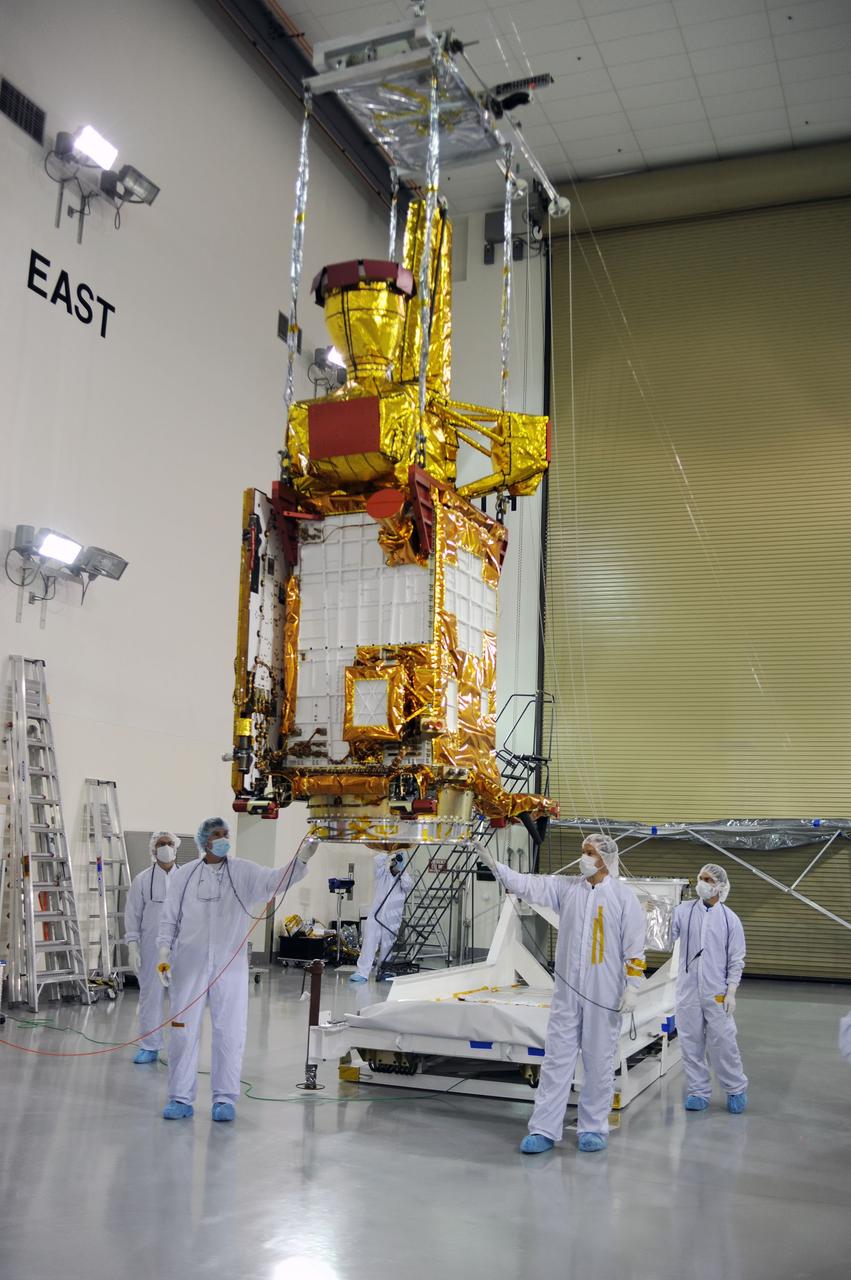 VANDENBERG AIR FORCE BASE, Calif. – Inside the Astrotech payload processing facility on Vandenberg Air Force Base in California, engineers and technicians use a crane to move a component of NASA's Soil Moisture Active Passive, or SMAP, spacecraft for a lift by a crane.    SMAP will launch on a Delta II 7320 configuration vehicle featuring a United Launch Alliance first stage booster powered by an Aerojet Rocketdyne RS-27A main engine and three Alliant Techsystems, or ATK, strap-on solid rocket motors. Once on station in Earth orbit, SMAP will provide global measurements of soil moisture and its freeze/thaw state. These measurements will be used to enhance understanding of processes that link the water, energy and carbon cycles, and to extend the capabilities of weather and climate prediction models. SMAP data also will be used to quantify net carbon flux in boreal landscapes and to develop improved flood prediction and drought monitoring capabilities. Launch from Space Launch Complex 2 is targeted for Jan. 29, 2015. To learn more about SMAP, visit http://smap.jpl.nasa.gov Photo credit: NASA/ Robert Rasmison