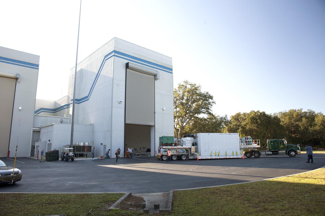 CAPE CANAVERAL, Fla. – The airlock door opens at Building 2 of the Astrotech payload processing facility in Titusville, Florida, near Kennedy Space Center, for ingress of the protective shipping container enclosing the Magnetospheric Multiscale spacecraft.    MMS is a Solar Terrestrial Probes mission comprising four identically instrumented spacecraft that will use Earth’s magnetosphere as a laboratory to study the microphysics of three fundamental plasma processes: magnetic reconnection, energetic particle acceleration and turbulence.  Launch aboard a United Launch Alliance Atlas V rocket from Space Launch Complex 41 on Cape Canaveral Air Force Station is targeted for March 12, 2015. To learn more about MMS, visit http://mms.gsfc.nasa.gov.  Photo credit: NASA/Kim Shiflett