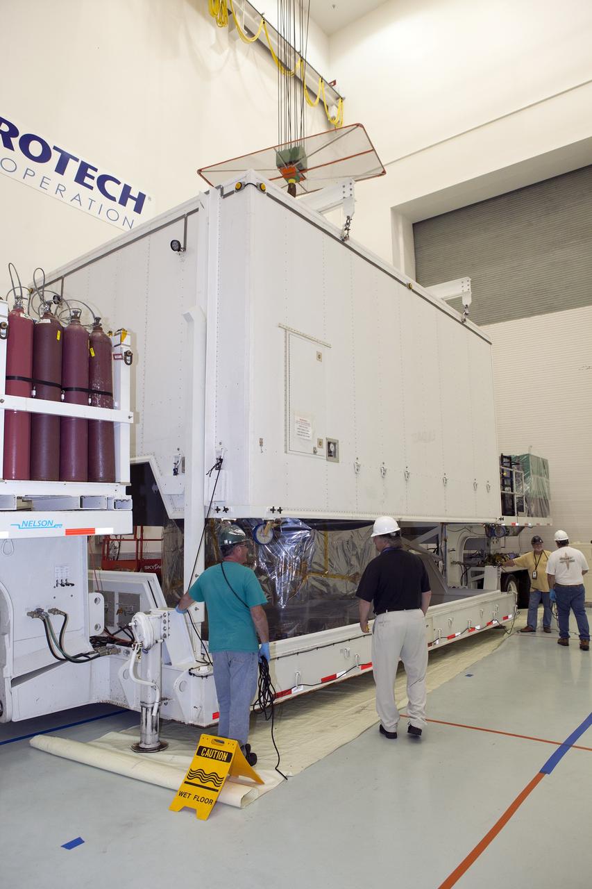 CAPE CANAVERAL, Fla. – The protective shipping container is lifted from the lower stack, mini-stack number 1, two of the observatories for NASA's Magnetospheric Multiscale Observatory, or MMS, in the Building 2 south encapsulation bay at the Astrotech payload processing facility in Titusville, Florida, near Kennedy Space Center.    The MMS upper stack, mini-stack number 2, is scheduled to arrive in about two weeks.  MMS is a Solar Terrestrial Probes mission comprising four identically instrumented spacecraft that will use Earth’s magnetosphere as a laboratory to study the microphysics of three fundamental plasma processes: magnetic reconnection, energetic particle acceleration and turbulence.  Launch aboard a United Launch Alliance Atlas V rocket from Space Launch Complex 41 on Cape Canaveral Air Force Station is targeted for March 12, 2015. To learn more about MMS, visit http://mms.gsfc.nasa.gov.  Photo credit: NASA/Dan Casper
