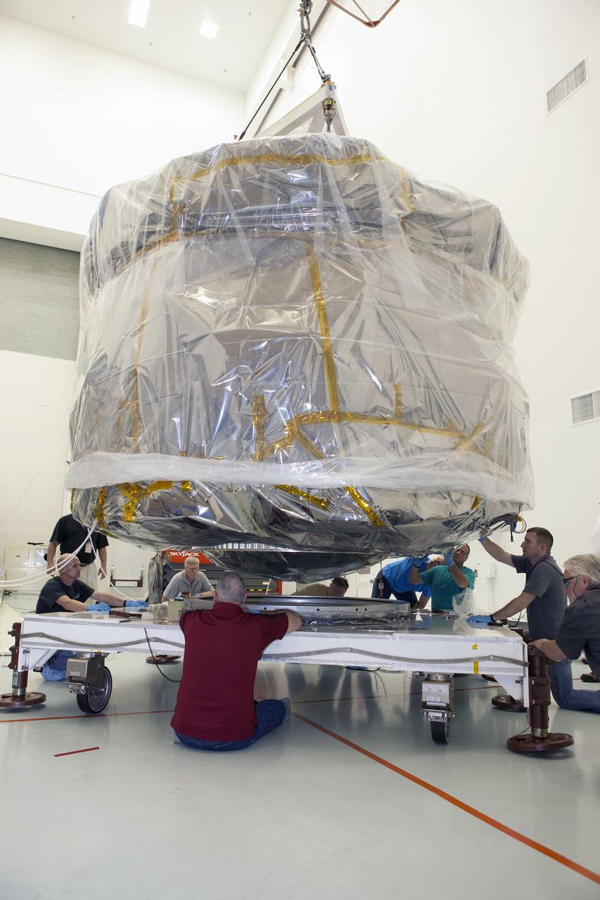 CAPE CANAVERAL, Fla. – Workers position two of the observatories, the lower stack, mini-stack number 1 for NASA's Magnetospheric Multiscale Observatory, or MMS, onto a payload dolly in the Building 2 south encapsulation bay at the Astrotech payload processing facility in Titusville, Florida, near Kennedy Space Center.    The MMS upper stack, mini-stack number 2, is scheduled to arrive in about two weeks.  MMS is a Solar Terrestrial Probes mission comprising four identically instrumented spacecraft that will use Earth’s magnetosphere as a laboratory to study the microphysics of three fundamental plasma processes: magnetic reconnection, energetic particle acceleration and turbulence.  Launch aboard a United Launch Alliance Atlas V rocket from Space Launch Complex 41 on Cape Canaveral Air Force Station is targeted for March 12, 2015. To learn more about MMS, visit http://mms.gsfc.nasa.gov.  Photo credit: NASA/Dan Casper
