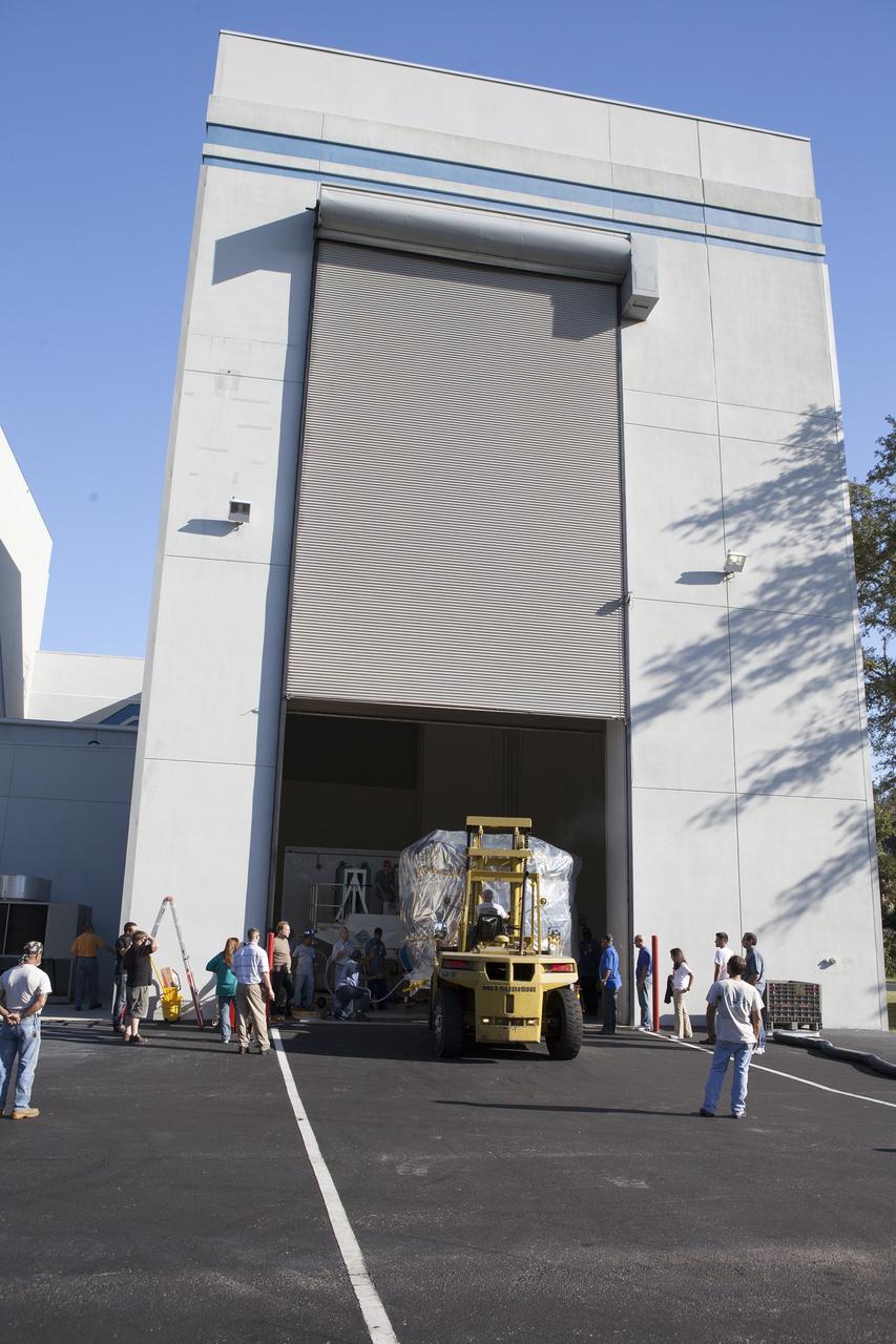CAPE CANAVERAL, Fla. – Two of the observatories for NASA's Magnetospheric Multiscale Observatory, or MMS, the lower stack, mini-stack number 1, begin the trip from the Building 2 south encapsulation bay to the Building 1 high bay at the Astrotech payload processing facility in Titusville, Florida, near Kennedy Space Center.    The MMS upper stack, mini-stack number 2, is scheduled to arrive in about two weeks.  MMS is a Solar Terrestrial Probes mission comprising four identically instrumented spacecraft that will use Earth’s magnetosphere as a laboratory to study the microphysics of three fundamental plasma processes: magnetic reconnection, energetic particle acceleration and turbulence.  Launch aboard a United Launch Alliance Atlas V rocket from Space Launch Complex 41 on Cape Canaveral Air Force Station is targeted for March 12, 2015. To learn more about MMS, visit http://mms.gsfc.nasa.gov.  Photo credit: NASA/Dan Casper