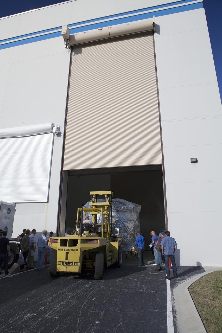 CAPE CANAVERAL, Fla. – Two of the observatories, the lower stack, mini-stack number 1, for NASA's Magnetospheric Multiscale Observatory, or MMS, roll into the Building 1 airlock at the Astrotech payload processing facility in Titusville, Florida, near Kennedy Space Center.    The MMS upper stack, mini-stack number 2, is scheduled to arrive in about two weeks.  MMS is a Solar Terrestrial Probes mission comprising four identically instrumented spacecraft that will use Earth’s magnetosphere as a laboratory to study the microphysics of three fundamental plasma processes: magnetic reconnection, energetic particle acceleration and turbulence.  Launch aboard a United Launch Alliance Atlas V rocket from Space Launch Complex 41 on Cape Canaveral Air Force Station is targeted for March 12, 2015. To learn more about MMS, visit http://mms.gsfc.nasa.gov.  Photo credit: NASA/Dan Casper