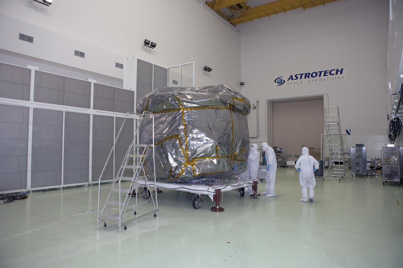 CAPE CANAVERAL, Fla. – Preparations are underway to remove the protective covering from the lower stack, mini-stack number 1, two of the observatories for NASA's Magnetospheric Multiscale Observatory, or MMS, in Building 1 D high bay at the Astrotech payload processing facility in Titusville, Florida, near Kennedy Space Center.    The MMS upper stack, mini-stack number 2, is scheduled to arrive in about two weeks.  MMS is a Solar Terrestrial Probes mission comprising four identically instrumented spacecraft that will use Earth’s magnetosphere as a laboratory to study the microphysics of three fundamental plasma processes: magnetic reconnection, energetic particle acceleration and turbulence.  Launch aboard a United Launch Alliance Atlas V rocket from Space Launch Complex 41 on Cape Canaveral Air Force Station is targeted for March 12, 2015. To learn more about MMS, visit http://mms.gsfc.nasa.gov.  Photo credit: NASA/Dan Casper