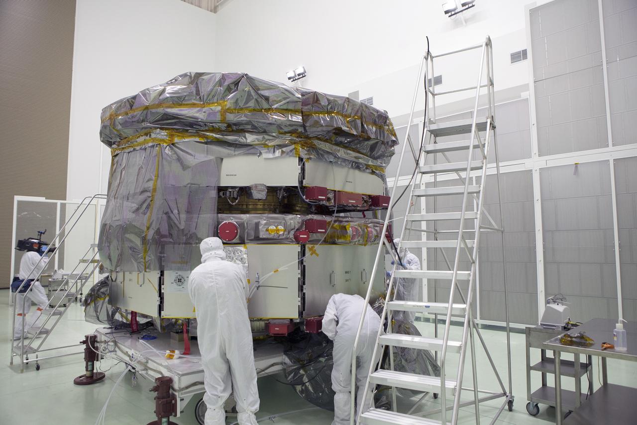 CAPE CANAVERAL, Fla. – Technicians remove the protective covering from the lower stack, mini-stack number 1, two of the observatories for NASA's Magnetospheric Multiscale Observatory, or MMS, in Building 1 D high bay at the Astrotech payload processing facility in Titusville, Florida, near Kennedy Space Center.    The MMS upper stack, mini-stack number 2, is scheduled to arrive in about two weeks.  MMS is a Solar Terrestrial Probes mission comprising four identically instrumented spacecraft that will use Earth’s magnetosphere as a laboratory to study the microphysics of three fundamental plasma processes: magnetic reconnection, energetic particle acceleration and turbulence.  Launch aboard a United Launch Alliance Atlas V rocket from Space Launch Complex 41 on Cape Canaveral Air Force Station is targeted for March 12, 2015. To learn more about MMS, visit http://mms.gsfc.nasa.gov.  Photo credit: NASA/Dan Casper