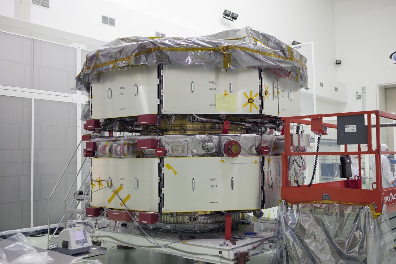 CAPE CANAVERAL, Fla. – Most of the protective covering has been removed from the lower stack, mini-stack number 1, two of the observatories for NASA's Magnetospheric Multiscale Observatory, or MMS, inside Building 1 D high bay at the Astrotech payload processing facility in Titusville, Florida, near Kennedy Space Center.    The MMS upper stack, mini-stack number 2, is scheduled to arrive in about two weeks.  MMS is a Solar Terrestrial Probes mission comprising four identically instrumented spacecraft that will use Earth’s magnetosphere as a laboratory to study the microphysics of three fundamental plasma processes: magnetic reconnection, energetic particle acceleration and turbulence.  Launch aboard a United Launch Alliance Atlas V rocket from Space Launch Complex 41 on Cape Canaveral Air Force Station is targeted for March 12, 2015. To learn more about MMS, visit http://mms.gsfc.nasa.gov.  Photo credit: NASA/Dan Casper