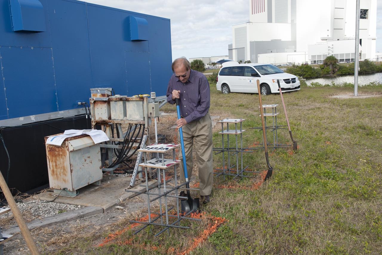 CAPE CANAVERAL, Fla. -- At NASA's Kennedy Space Center in Florida, Public Affairs Officer George Diller digs in behind the current countdown clock during the groundbreaking ceremony for the new countdown clock. The old timepiece was designed by Kennedy engineers and built by Kennedy technicians in 1969. Not including the triangular concrete and aluminum base, the famous landmark is nearly 6 feet 70 inches high, 26 feet 315 inches wide and 3 feet deep. The new display will be similar in size, with the screen being nearly 26 feet wide by 7 feet high. For more information on the countdown clock, go to http://go.nasa.gov/10Zku10. Photo credit: NASA/Jim Grossmann
