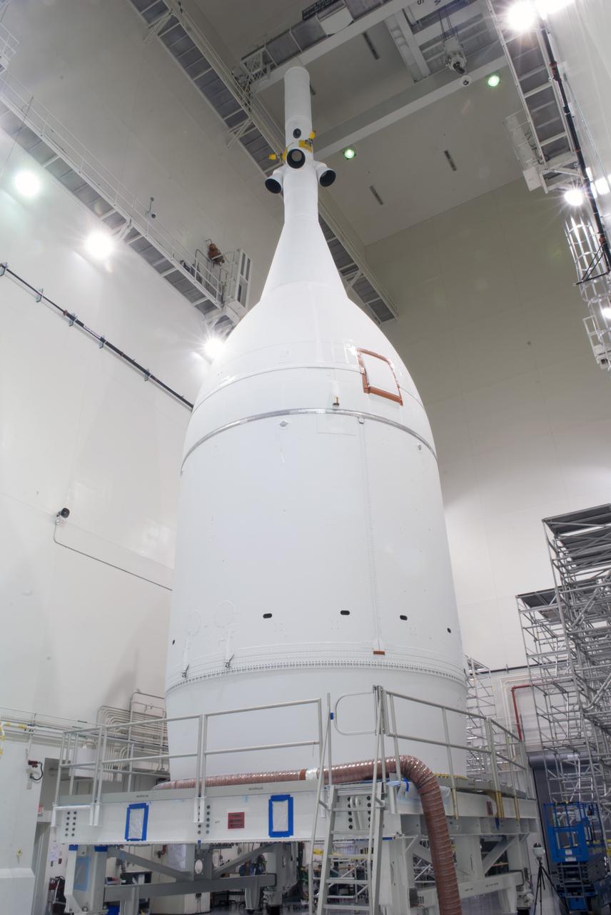 CAPE CANAVERAL, Fla. – The Orion spacecraft sits inside the Launch Abort System Facility at NASA's Kennedy Space Center in Florida. The Ogive panels have been installed around the launch abort system. The panels will smooth the airflow over the conical spacecraft to limit sound and vibration, which will make for a much smoother ride for the astronauts who will ride inside Orion in the future. The spacecraft is being readied for its move to Space Launch Complex 37 at Cape Canaveral Air Force Station for its flight test. Orion is the exploration spacecraft designed to carry astronauts to destinations not yet explored by humans, including an asteroid and Mars. It will have emergency abort capability, sustain the crew during space travel and provide safe re-entry from deep space return velocities. The first unpiloted flight test of Orion is scheduled to launch in December 2014 atop a United Launch Alliance Delta IV Heavy rocket, and in 2018 on NASA’s Space Launch System rocket. For more information, visit www.nasa.gov/orion. Photo credit: Jim Grossman