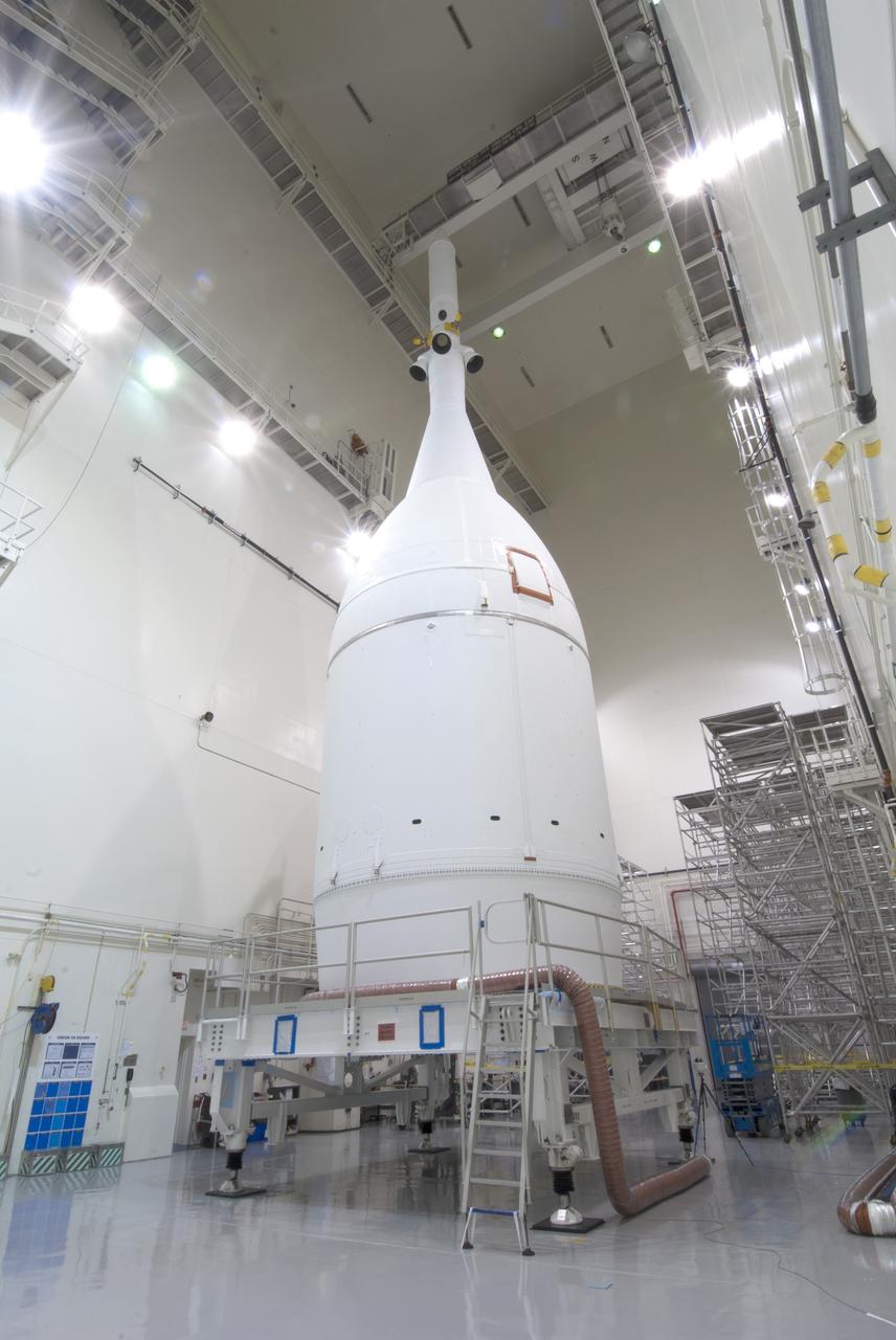 CAPE CANAVERAL, Fla. – The Orion spacecraft sits inside the Launch Abort System Facility at NASA's Kennedy Space Center in Florida. The Ogive panels have been installed around the launch abort system. The panels will smooth the airflow over the conical spacecraft to limit sound and vibration, which will make for a much smoother ride for the astronauts who will ride inside Orion in the future. The spacecraft is being readied for its move to Space Launch Complex 37 at Cape Canaveral Air Force Station for its flight test. Orion is the exploration spacecraft designed to carry astronauts to destinations not yet explored by humans, including an asteroid and Mars. It will have emergency abort capability, sustain the crew during space travel and provide safe re-entry from deep space return velocities. The first unpiloted flight test of Orion is scheduled to launch in December 2014 atop a United Launch Alliance Delta IV Heavy rocket, and in 2018 on NASA’s Space Launch System rocket. For more information, visit www.nasa.gov/orion. Photo credit: Jim Grossman