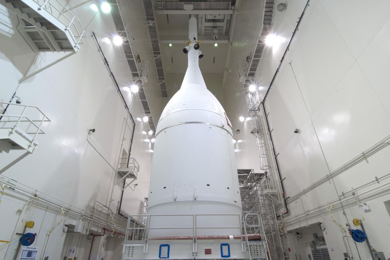 CAPE CANAVERAL, Fla. – The Orion spacecraft sits inside the Launch Abort System Facility at NASA's Kennedy Space Center in Florida. The Ogive panels have been installed around the launch abort system. The panels will smooth the airflow over the conical spacecraft to limit sound and vibration, which will make for a much smoother ride for the astronauts who will ride inside Orion in the future. The spacecraft is being readied for its move to Space Launch Complex 37 at Cape Canaveral Air Force Station for its flight test. Orion is the exploration spacecraft designed to carry astronauts to destinations not yet explored by humans, including an asteroid and Mars. It will have emergency abort capability, sustain the crew during space travel and provide safe re-entry from deep space return velocities. The first unpiloted flight test of Orion is scheduled to launch in December 2014 atop a United Launch Alliance Delta IV Heavy rocket, and in 2018 on NASA’s Space Launch System rocket. For more information, visit www.nasa.gov/orion. Photo credit: Jim Grossman