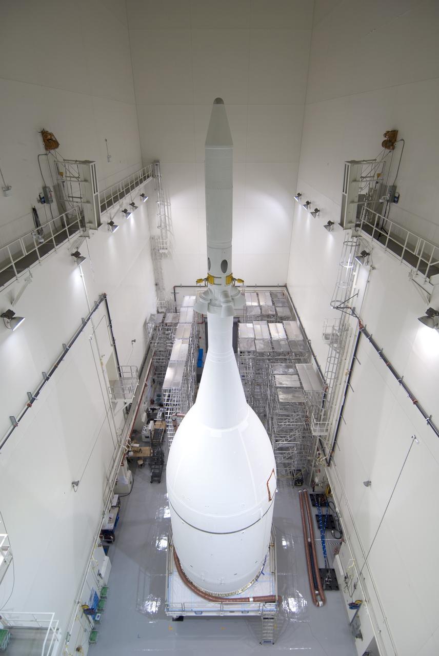 CAPE CANAVERAL, Fla. – The Orion spacecraft sits inside the Launch Abort System Facility at NASA's Kennedy Space Center in Florida. The Ogive panels have been installed around the launch abort system. The panels will smooth the airflow over the conical spacecraft to limit sound and vibration, which will make for a much smoother ride for the astronauts who will ride inside Orion in the future. The spacecraft is being readied for its move to Space Launch Complex 37 at Cape Canaveral Air Force Station for its flight test.    Orion is the exploration spacecraft designed to carry astronauts to destinations not yet explored by humans, including an asteroid and Mars. It will have emergency abort capability, sustain the crew during space travel and provide safe re-entry from deep space return velocities. The first unpiloted flight test of Orion is scheduled to launch in December 2014 atop a United Launch Alliance Delta IV Heavy rocket, and in 2018 on NASA’s Space Launch System rocket. For more information, visit www.nasa.gov/orion. Photo credit: Jim Grossman