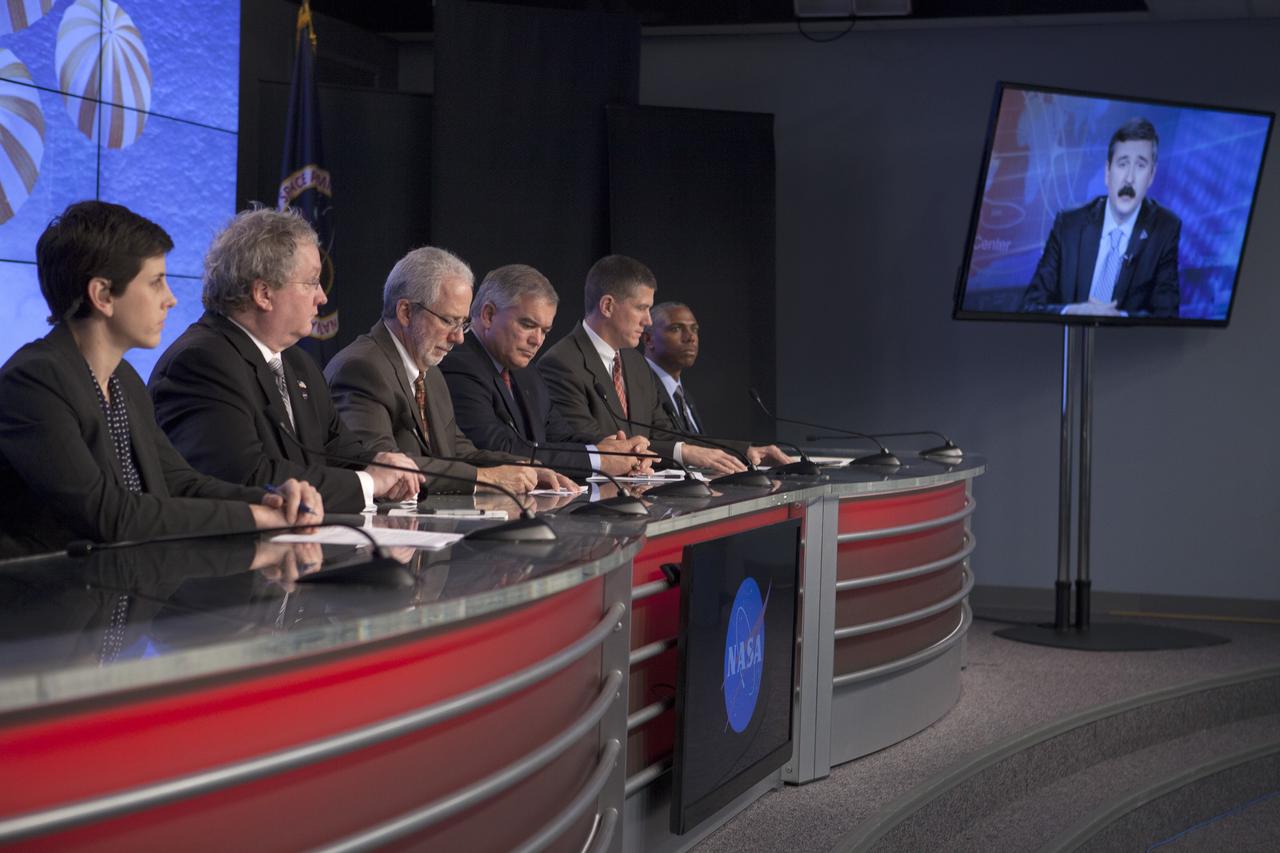 CAPE CANAVERAL, Fla. – In the Kennedy Space Center’s Press Site auditorium, members of the news media are briefed on the upcoming Orion flight test. From left are: Rachel Kraft, NASA Public Affairs, Bill Hill, NASA deputy associate administrator for Exploration Systems Development, Mark Geyer, NASA Orion Program manager, Bryan Austin, Lockheed Martin mission manager, Jeremy Graeber, Operations Integration Branch of Ground Systems Development and Operations at Kennedy, and Ron Fortson, United Launch Alliance director of Mission Management. Mike Sarafin, NASA's lead flight director, participated by video from the Johnson Space Center.      Orion is the exploration spacecraft designed to carry astronauts to destinations not yet explored by humans, including an asteroid and Mars. It will have emergency abort capability, sustain the crew during space travel and provide safe re-entry from deep space return velocities. The first unpiloted flight test of Orion is scheduled to launch Dec. 4, 2014 atop a United Launch Alliance Delta IV Heavy rocket, and in 2018 on NASA’s Space Launch System rocket. For more information, visit www.nasa.gov/orion Photo credit: NASA/Kim Shiflett