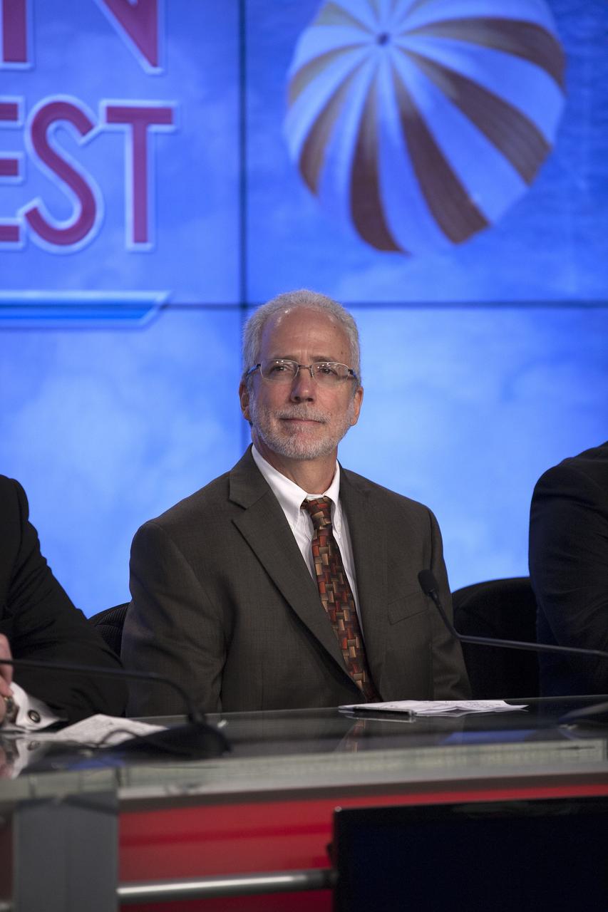 CAPE CANAVERAL, Fla. – In the Kennedy Space Center’s Press Site auditorium, members of the news media are briefed on the upcoming Orion flight test by Mark Geyer, NASA Orion Program manager.      Orion is the exploration spacecraft designed to carry astronauts to destinations not yet explored by humans, including an asteroid and Mars. It will have emergency abort capability, sustain the crew during space travel and provide safe re-entry from deep space return velocities. The first unpiloted flight test of Orion is scheduled to launch Dec. 4, 2014 atop a United Launch Alliance Delta IV Heavy rocket, and in 2018 on NASA’s Space Launch System rocket. For more information, visit www.nasa.gov/orion Photo credit: NASA/Kim Shiflett