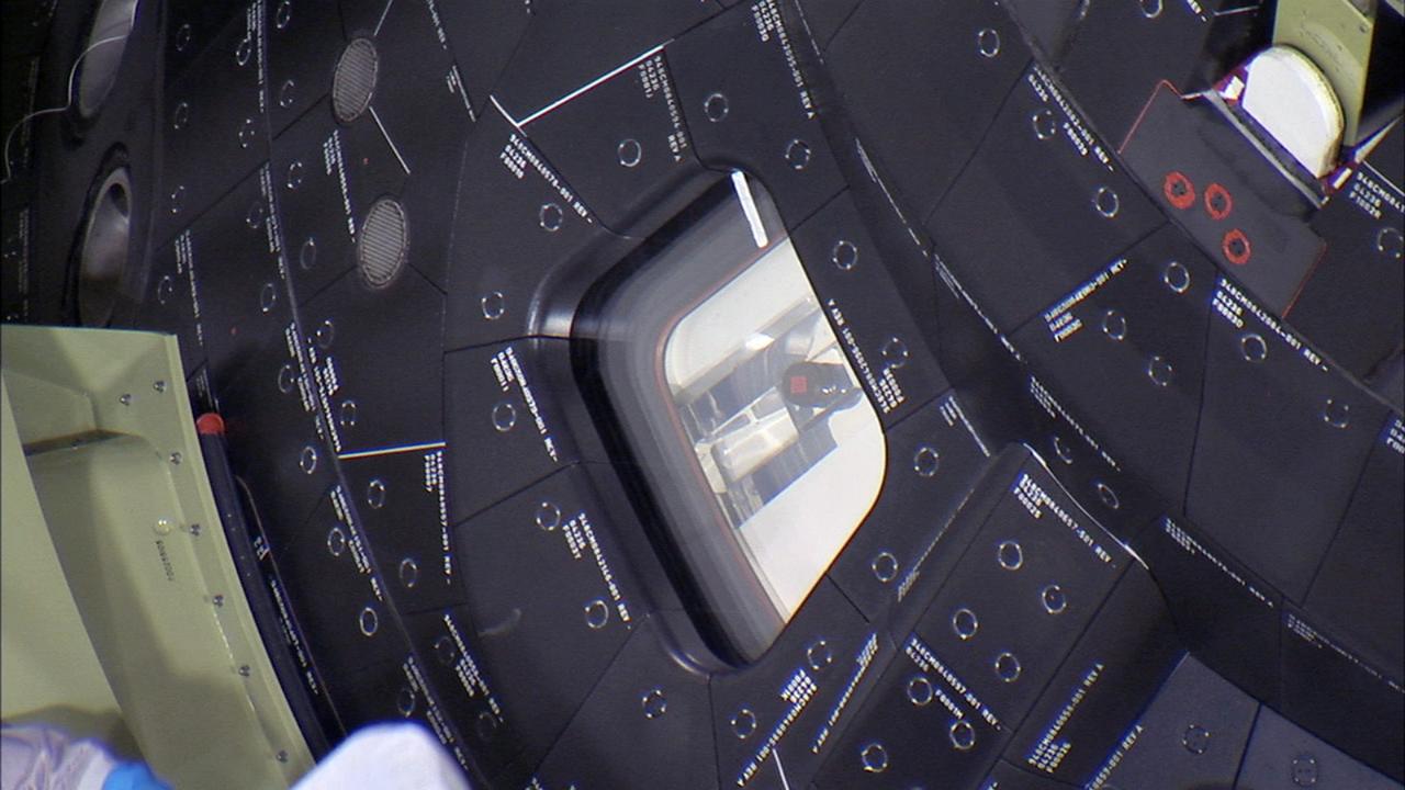 CAPE CANAVERAL, Fla. – Inside the Launch Abort System Facility at NASA’s Kennedy Space Center in Florida, a window cover has been carefully removed from the Orion spacecraft before the fourth and final Ogive panel is installed around the spacecraft and Launch Abort System. The Ogive panels will smooth the airflow over the conical spacecraft to limit sound and vibration, which will make for a much smoother ride for the astronauts who will ride inside Orion in the future. The work marked the final major assembly steps for the spacecraft before it is transported to Space Launch Complex 37 at Cape Canaveral Air Force Station in November. Orion is the exploration spacecraft designed to carry astronauts to destinations not yet explored by humans, including an asteroid and Mars. It will have emergency abort capability, sustain the crew during space travel and provide safe re-entry from deep space return velocities. The first unpiloted flight test of Orion is scheduled to launch in December 2014 atop a United Launch Alliance Delta IV Heavy rocket, and in 2018 on NASA’s Space Launch System rocket. For more information, visit www.nasa.gov/orion. Photo credit: Ben Smegelsky