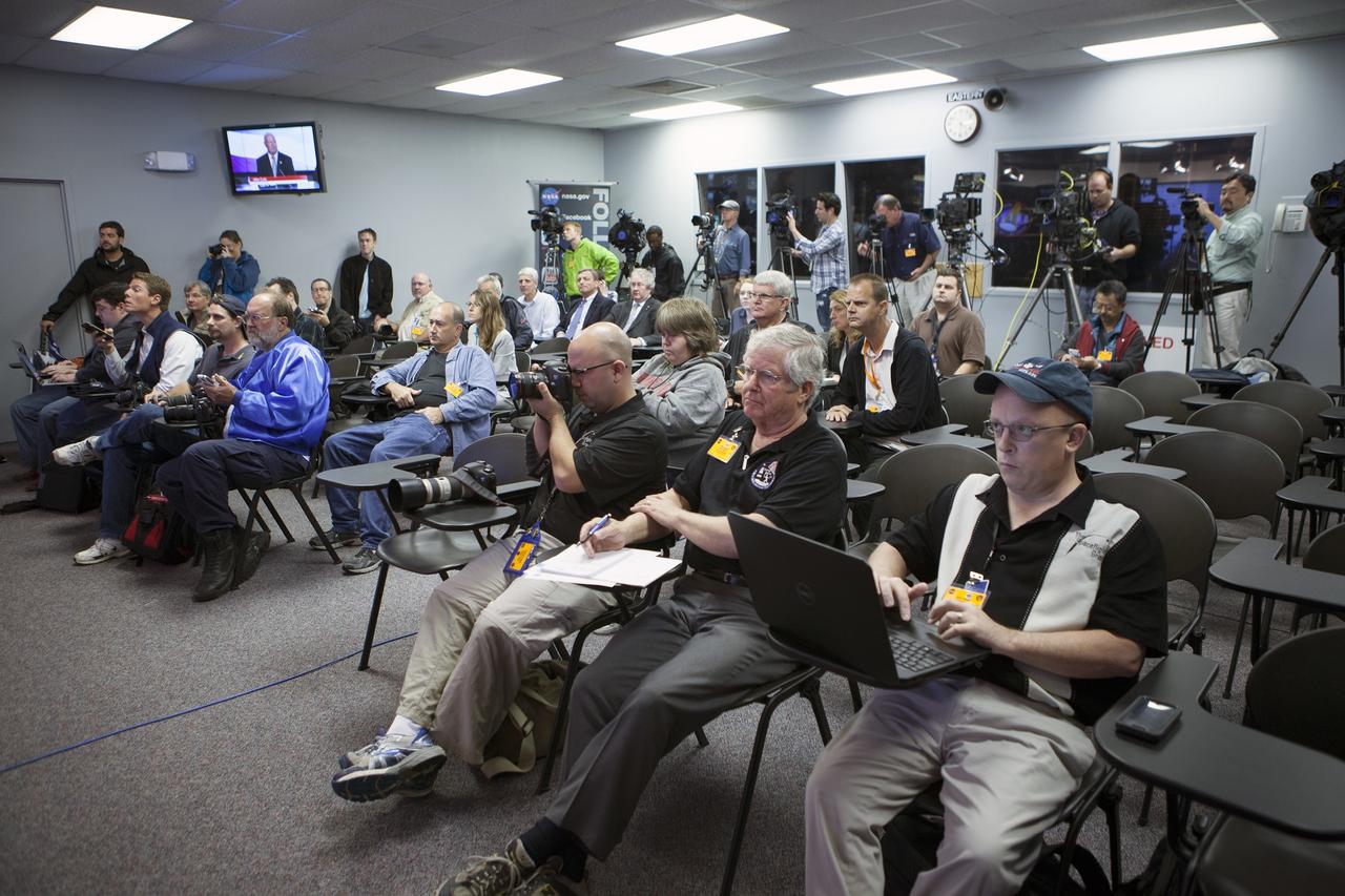 CAPE CANAVERAL, Fla. – In the Kennedy Space Center’s Press Site auditorium, members of the news media listen as NASA and contractor officials discuss plans for moving the completed Orion spacecraft from the Launch Abort System Facility to Launch Complex 37 at Cape Canaveral Air Force Station.    Orion is the exploration spacecraft designed to carry astronauts to destinations not yet explored by humans, including an asteroid and Mars. It will have emergency abort capability, sustain the crew during space travel and provide safe re-entry from deep space return velocities. The first unpiloted flight test of Orion is scheduled to launch Dec. 4, 2014 atop a United Launch Alliance Delta IV Heavy rocket, and in 2018 on NASA’s Space Launch System rocket. For more information, visit www.nasa.gov/orion Photo credit: NASA/Kim Shiflett