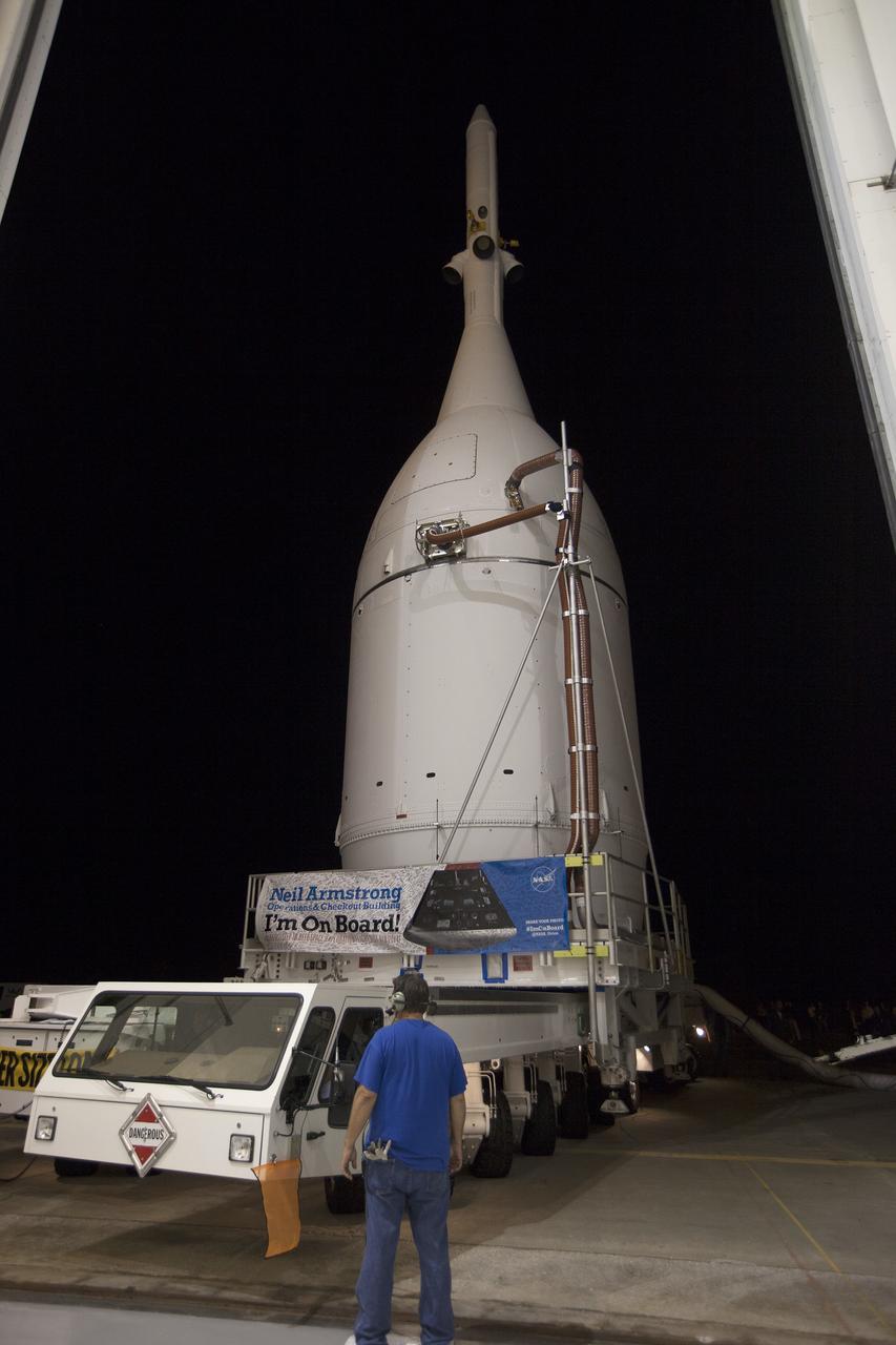 CAPE CANAVERAL, Fla. – At NASA's Kennedy Space Center in Florida, the agency's completed Orion spacecraft begins its trip from the Launch Abort System Facility to Launch Complex 37 at Cape Canaveral Air Force Station. Orion spent many months in Kennedy's Neil Armstrong Operations and Checkout Building undergoing final assembly. Hundreds of employees who work there signed the banner that states, "I'm On Board!" In doing so, their signature indicated they did their part to ensure mission success. After arrival at the launch pad, United Launch Alliance engineers and technicians will lift Orion and mount it atop its Delta IV Heavy rocket.      Orion is the exploration spacecraft designed to carry astronauts to destinations not yet explored by humans, including an asteroid and Mars. It will have emergency abort capability, sustain the crew during space travel and provide safe re-entry from deep space return velocities. The first unpiloted flight test of Orion is scheduled to launch Dec. 4, 2014 atop a United Launch Alliance Delta IV Heavy rocket, and in 2018 on NASA’s Space Launch System rocket. For more information, visit www.nasa.gov/orion Photo credit: NASA/Kim Shiflett
