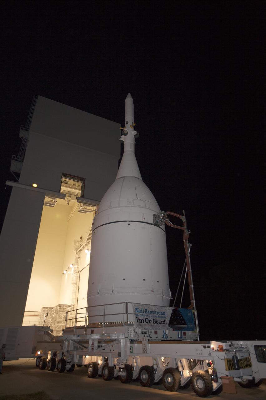 CAPE CANAVERAL, Fla. – At NASA's Kennedy Space Center in Florida, the agency's completed Orion spacecraft begins its trip from the Launch Abort System Facility to Launch Complex 37 at Cape Canaveral Air Force Station. Orion spent many months in Kennedy's Neil Armstrong Operations and Checkout Building undergoing final assembly. Hundreds of employees who work there signed the banner that states, "I'm On Board!" In doing so, their signature indicated they did their part to ensure mission success. After arrival at the launch pad, United Launch Alliance engineers and technicians will lift Orion and mount it atop its Delta IV Heavy rocket.      Orion is the exploration spacecraft designed to carry astronauts to destinations not yet explored by humans, including an asteroid and Mars. It will have emergency abort capability, sustain the crew during space travel and provide safe re-entry from deep space return velocities. The first unpiloted flight test of Orion is scheduled to launch Dec. 4, 2014 atop a United Launch Alliance Delta IV Heavy rocket, and in 2018 on NASA’s Space Launch System rocket. For more information, visit www.nasa.gov/orion Photo credit: NASA/Kim Shiflett