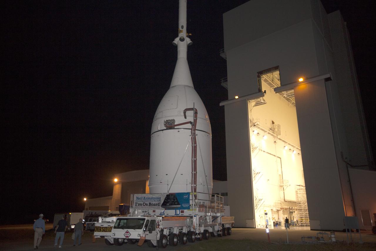 CAPE CANAVERAL, Fla. – At NASA's Kennedy Space Center in Florida, the agency's completed Orion spacecraft begins its trip from the Launch Abort System Facility to Launch Complex 37 at Cape Canaveral Air Force Station. Orion spent many months in Kennedy's Neil Armstrong Operations and Checkout Building undergoing final assembly. Hundreds of employees who work there signed the banner that states, "I'm On Board!" In doing so, their signature indicated they did their part to ensure mission success. After arrival at the launch pad, United Launch Alliance engineers and technicians will lift Orion and mount it atop its Delta IV Heavy rocket.      Orion is the exploration spacecraft designed to carry astronauts to destinations not yet explored by humans, including an asteroid and Mars. It will have emergency abort capability, sustain the crew during space travel and provide safe re-entry from deep space return velocities. The first unpiloted flight test of Orion is scheduled to launch Dec. 4, 2014 atop a United Launch Alliance Delta IV Heavy rocket, and in 2018 on NASA’s Space Launch System rocket. For more information, visit www.nasa.gov/orion Photo credit: NASA/Kim Shiflett