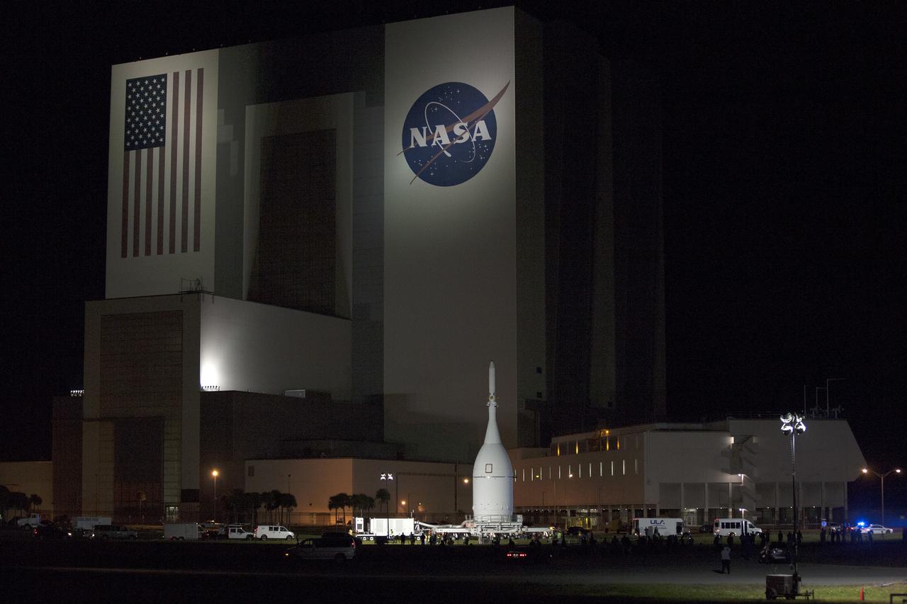 CAPE CANAVERAL, Fla. – At NASA's Kennedy Space Center in Florida, the agency's Orion spacecraft passes the spaceport's iconic Vehicle Assembly Building as it is transported to Launch Complex 37 at Cape Canaveral Air Force Station. After arrival at the launch pad, United Launch Alliance engineers and technicians will lift Orion and mount it atop its Delta IV Heavy rocket.      Orion is the exploration spacecraft designed to carry astronauts to destinations not yet explored by humans, including an asteroid and Mars. It will have emergency abort capability, sustain the crew during space travel and provide safe re-entry from deep space return velocities. The first unpiloted flight test of Orion is scheduled to launch Dec. 4, 2014 atop a United Launch Alliance Delta IV Heavy rocket, and in 2018 on NASA’s Space Launch System rocket. For more information, visit www.nasa.gov/orion Photo credit: NASA/Kim Shiflett