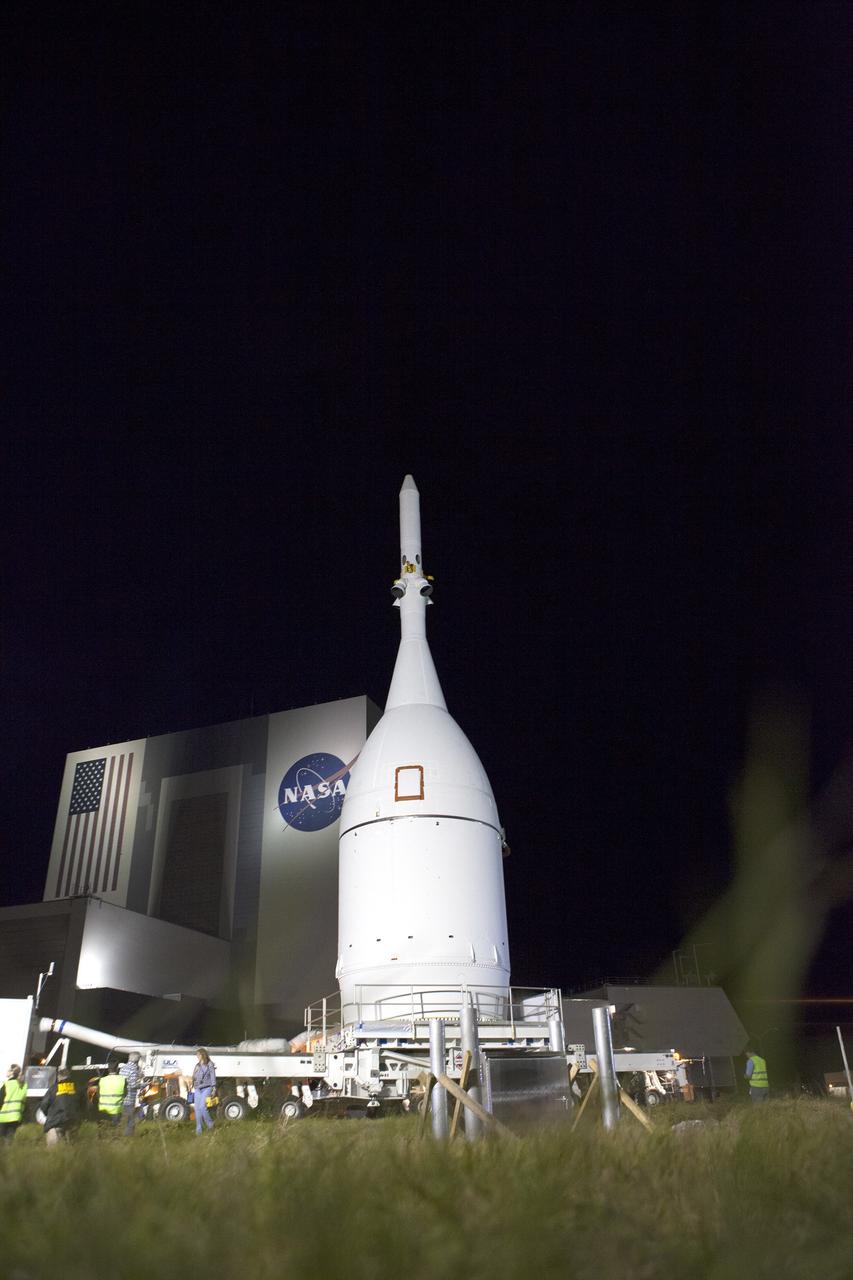 CAPE CANAVERAL, Fla. – At NASA's Kennedy Space Center in Florida, the agency's Orion spacecraft passes the spaceport's iconic Vehicle Assembly Building as it is transported to Launch Complex 37 at Cape Canaveral Air Force Station. After arrival at the launch pad, United Launch Alliance engineers and technicians will lift Orion and mount it atop its Delta IV Heavy rocket.      Orion is the exploration spacecraft designed to carry astronauts to destinations not yet explored by humans, including an asteroid and Mars. It will have emergency abort capability, sustain the crew during space travel and provide safe re-entry from deep space return velocities. The first unpiloted flight test of Orion is scheduled to launch Dec. 4, 2014 atop a United Launch Alliance Delta IV Heavy rocket, and in 2018 on NASA’s Space Launch System rocket. For more information, visit www.nasa.gov/orion Photo credit: NASA/Frankie Martin