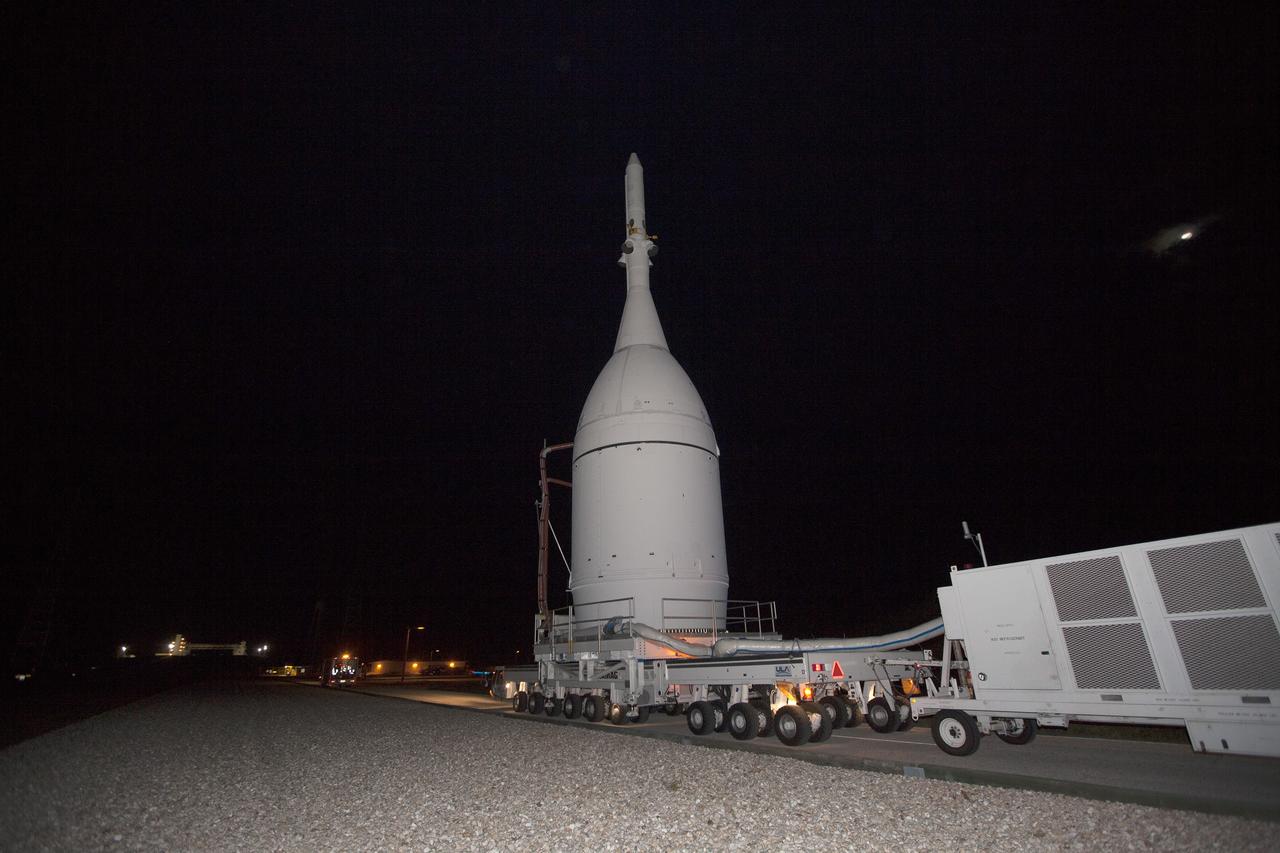 CAPE CANAVERAL, Fla. – At NASA's Kennedy Space Center in Florida, the agency's Orion spacecraft approaches the spaceport's Launch Complex 39B as it is transported to Launch Complex 37 at Cape Canaveral Air Force Station. After arrival at the launch pad, United Launch Alliance engineers and technicians will lift Orion and mount it atop its Delta IV Heavy rocket.    Orion is the exploration spacecraft designed to carry astronauts to destinations not yet explored by humans, including an asteroid and Mars. It will have emergency abort capability, sustain the crew during space travel and provide safe re-entry from deep space return velocities. The first unpiloted flight test of Orion is scheduled to launch Dec. 4, 2014 atop a United Launch Alliance Delta IV Heavy rocket, and in 2018 on NASA’s Space Launch System rocket. For more information, visit www.nasa.gov/orion Photo credit: NASA/Kim Shiflett