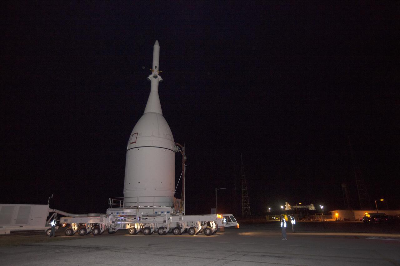 CAPE CANAVERAL, Fla. – At NASA's Kennedy Space Center in Florida, the agency's Orion spacecraft passes the spaceport's Launch Complex 39B as it is transported to Launch Complex 37 at Cape Canaveral Air Force Station. After arrival at the launch pad, United Launch Alliance engineers and technicians will lift Orion and mount it atop its Delta IV Heavy rocket. Orion is the exploration spacecraft designed to carry astronauts to destinations not yet explored by humans, including an asteroid and Mars. It will have emergency abort capability, sustain the crew during space travel and provide safe re-entry from deep space return velocities. The first unpiloted flight test of Orion is scheduled to launch Dec. 4, 2014 atop a United Launch Alliance Delta IV Heavy rocket, and in 2018 on NASA’s Space Launch System rocket. For more information, visit www.nasa.gov/orion Photo credit: NASA/Kim Shiflett