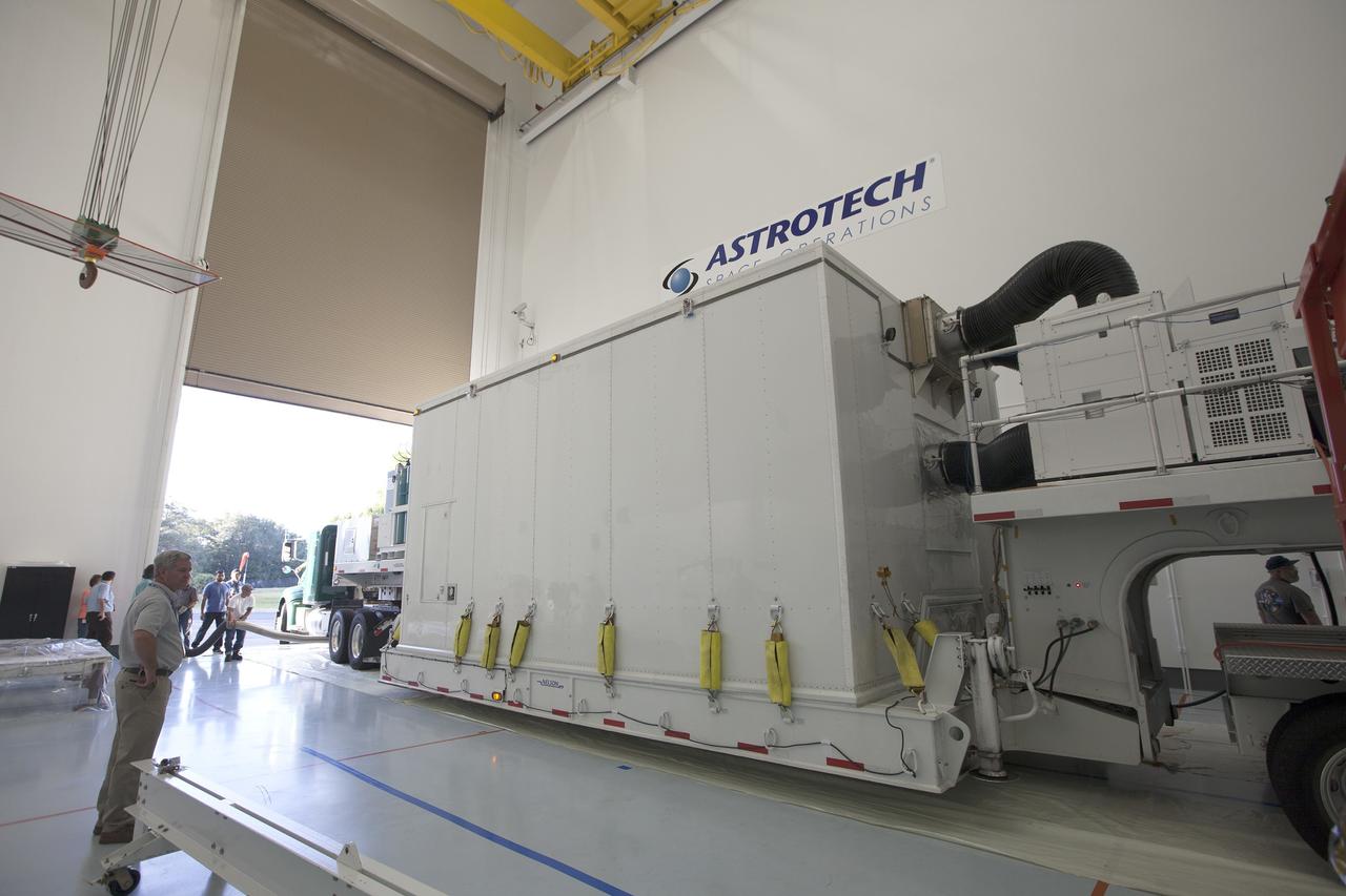 CAPE CANAVERAL, Fla. – Two Magnetospheric Multiscale spacecraft, enclosed in a protective shipping container, are positioned into the airlock of Building 2 of the Astrotech payload processing facility in Titusville, Florida, near Kennedy Space Center.    The Magnetospheric Multiscale mission, or MMS, is a Solar Terrestrial Probes mission comprising four identically instrumented spacecraft that will use Earth’s magnetosphere as a laboratory to study the microphysics of three fundamental plasma processes: magnetic reconnection, energetic particle acceleration and turbulence. These two spacecraft comprise the mission's upper stack. The two MMS spacecraft comprising the lower stack arrived at Astrotech on Oct. 29. Launch aboard a United Launch Alliance Atlas V rocket from Space Launch Complex 41 on Cape Canaveral Air Force Station is targeted for March 12, 2015. To learn more about MMS, visit http://mms.gsfc.nasa.gov.  Photo credit: NASA/Kim Shiflett