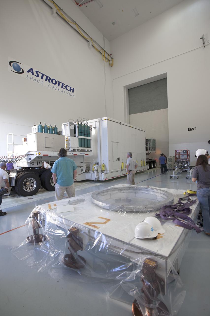 CAPE CANAVERAL, Fla. – Operations are underway to remove two of the the Magnetospheric Multiscale spacecraft from their protective shipping container in the airlock of Building 2 at the Astrotech payload processing facility in Titusville, Florida, near Kennedy Space Center.    The Magnetospheric Multiscale mission, or MMS, is a Solar Terrestrial Probes mission comprising four identically instrumented spacecraft that will use Earth’s magnetosphere as a laboratory to study the microphysics of three fundamental plasma processes: magnetic reconnection, energetic particle acceleration and turbulence. These two spacecraft comprise the mission's upper stack. The two MMS spacecraft comprising the lower stack arrived at Astrotech on Oct. 29. Launch aboard a United Launch Alliance Atlas V rocket from Space Launch Complex 41 on Cape Canaveral Air Force Station is targeted for March 12, 2015. To learn more about MMS, visit http://mms.gsfc.nasa.gov.  Photo credit: NASA/Kim Shiflett