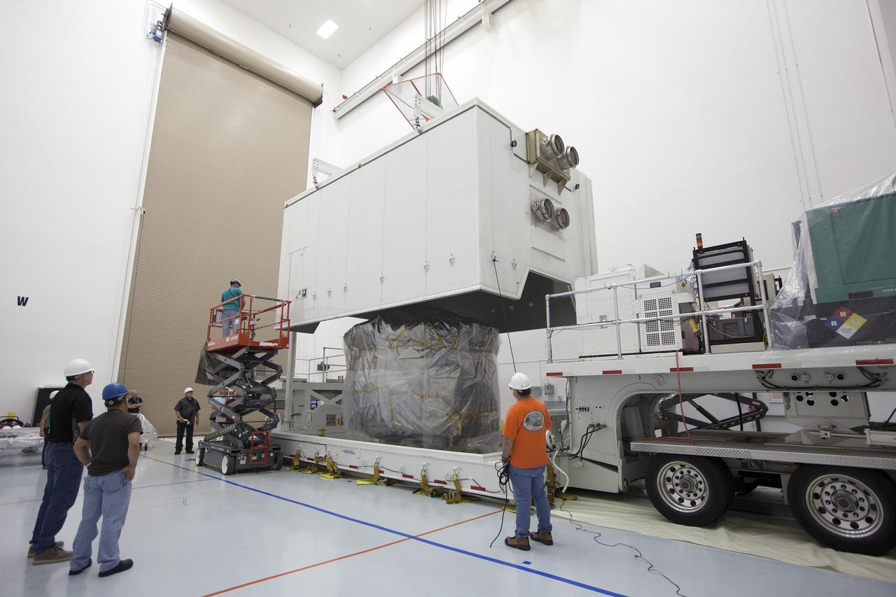CAPE CANAVERAL, Fla. – Two Magnetospheric Multiscale, or MMS, spacecraft, comprising the mission's upper stack, come into view as the shipping container is removed in Building 2 of the Astrotech payload processing facility in Titusville, Florida, near Kennedy Space Center. The two MMS spacecraft comprising the lower stack arrived at Astrotech on Oct. 29. The Magnetospheric Multiscale mission is a Solar Terrestrial Probes mission comprising four identically instrumented spacecraft that will use Earth’s magnetosphere as a laboratory to study the microphysics of three fundamental plasma processes: magnetic reconnection, energetic particle acceleration and turbulence. Launch aboard a United Launch Alliance Atlas V rocket from Space Launch Complex 41 on Cape Canaveral Air Force Station is targeted for March 12, 2015. To learn more about MMS, visit http://mms.gsfc.nasa.gov.  Photo credit: NASA/Kim Shiflett
