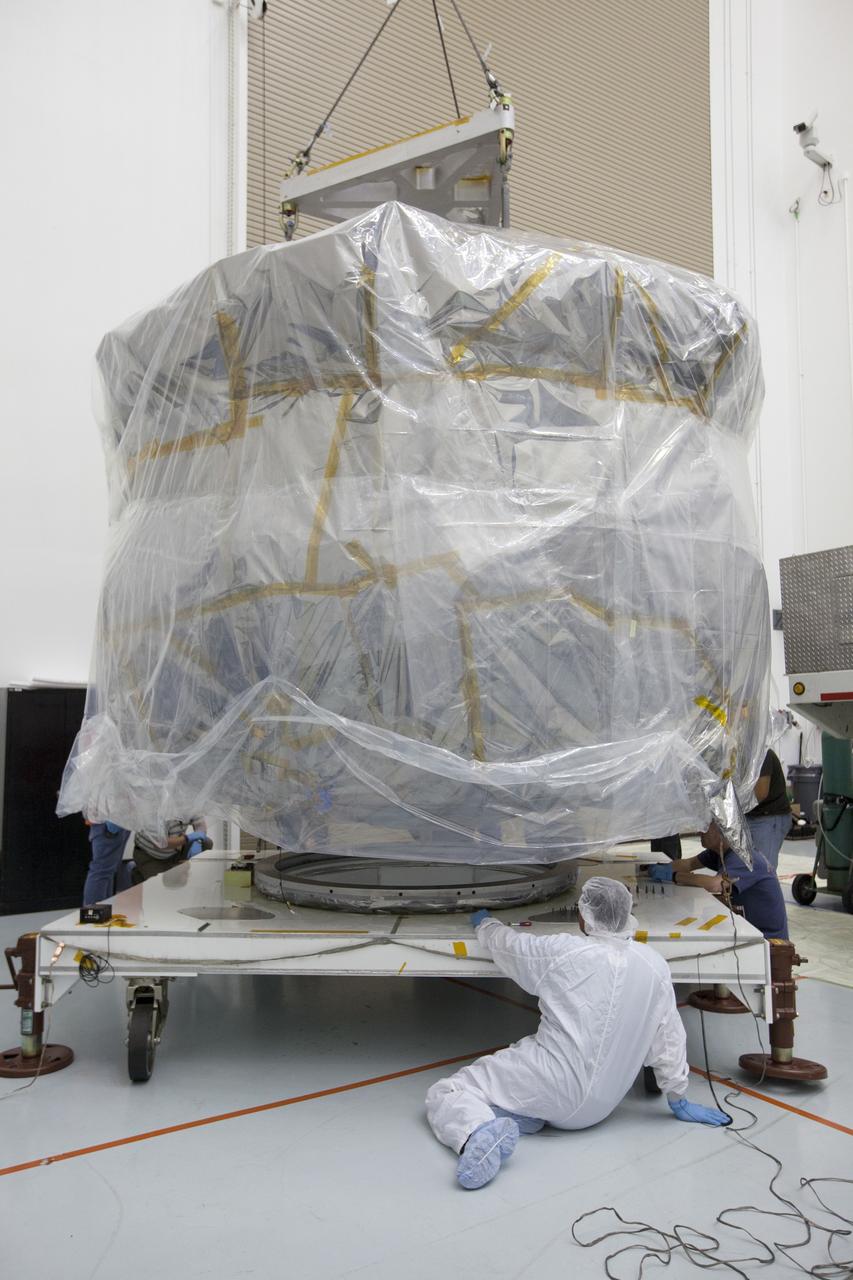 CAPE CANAVERAL, Fla. – Two Magnetospheric Multiscale , or MMS, spacecraft comprising the mission’s upper stack are lowered onto a payload dolly in Building 2 of the Astrotech payload processing facility in Titusville, Florida, near Kennedy Space Center. The two MMS spacecraft comprising the lower stack arrived at Astrotech on Oct. 29. The Magnetospheric Multiscale mission is a Solar Terrestrial Probes mission comprising four identically instrumented spacecraft that will use Earth’s magnetosphere as a laboratory to study the microphysics of three fundamental plasma processes: magnetic reconnection, energetic particle acceleration and turbulence. Launch aboard a United Launch Alliance Atlas V rocket from Space Launch Complex 41 on Cape Canaveral Air Force Station is targeted for March 12, 2015. To learn more about MMS, visit http://mms.gsfc.nasa.gov.  Photo credit: NASA/Kim Shiflett