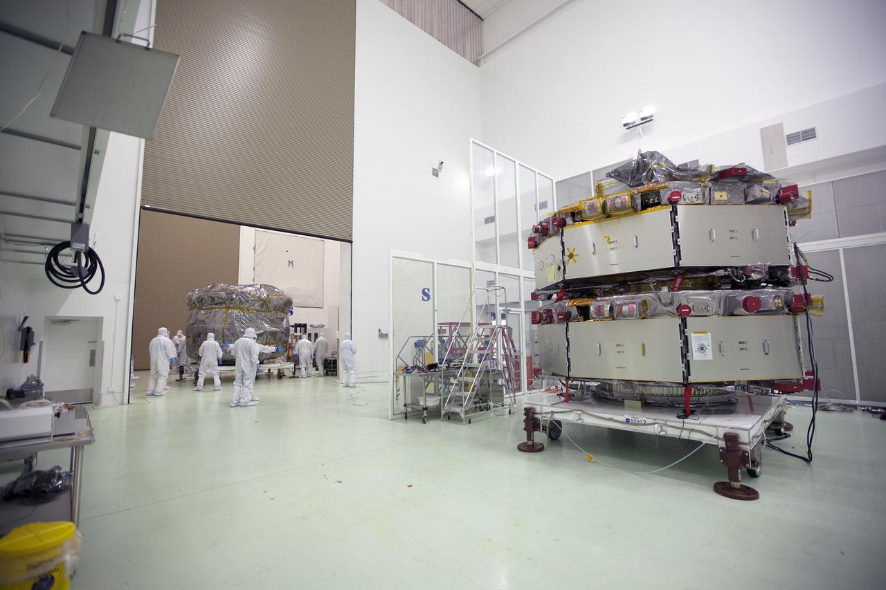 CAPE CANAVERAL, Fla. – Two Magnetospheric Multiscale, or MMS, spacecraft comprising the mission’s upper stack arrive in the Building 1 airlock of the Astrotech payload processing facility in Titusville, Florida, near Kennedy Space Center. The two MMS spacecraft comprising the lower stack, in the high bay uat right, arrived at Astrotech on Oct. 29. The Magnetospheric Multiscale mission is a Solar Terrestrial Probes mission comprising four identically instrumented spacecraft that will use Earth’s magnetosphere as a laboratory to study the microphysics of three fundamental plasma processes: magnetic reconnection, energetic particle acceleration and turbulence. Launch aboard a United Launch Alliance Atlas V rocket from Space Launch Complex 41 on Cape Canaveral Air Force Station is targeted for March 12, 2015. To learn more about MMS, visit http://mms.gsfc.nasa.gov.  Photo credit: NASA/Kim Shiflett