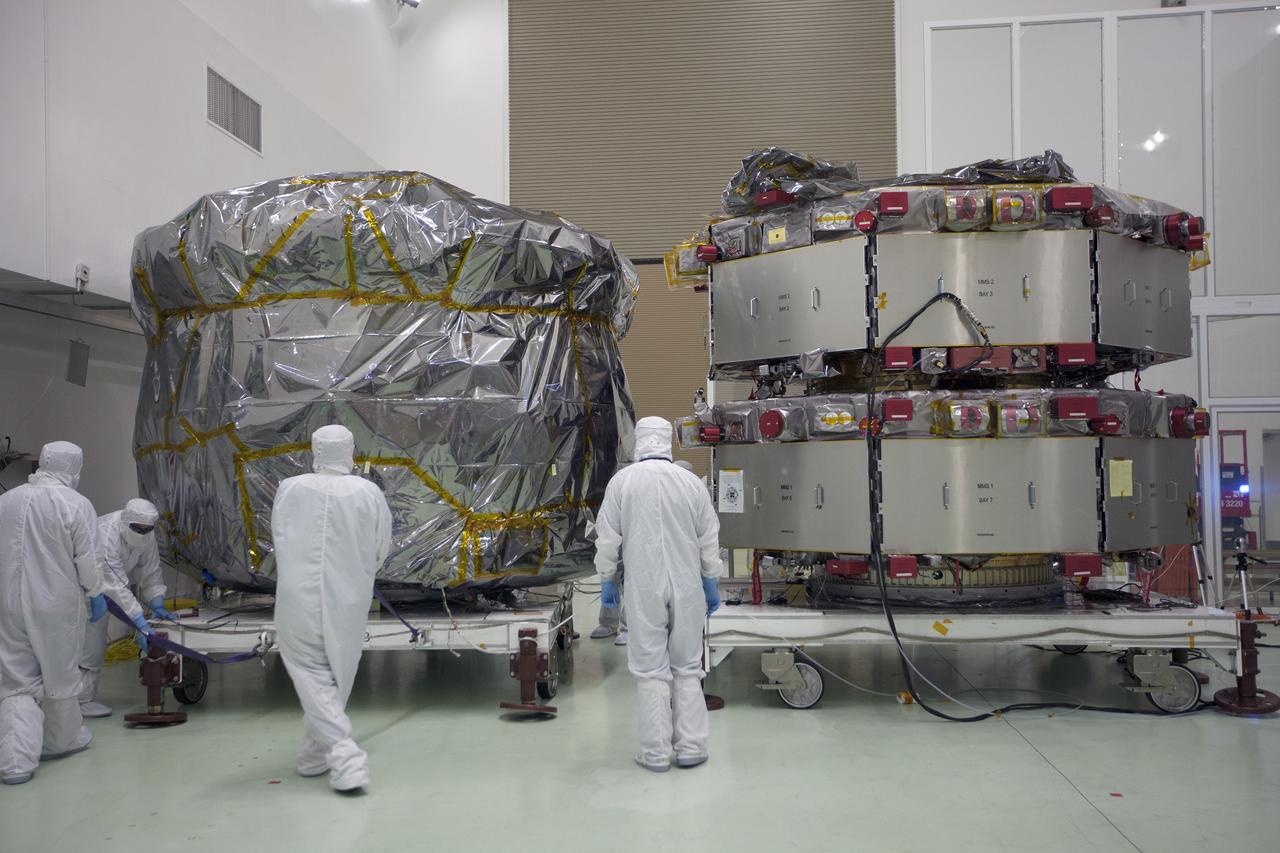 CAPE CANAVERAL, Fla. – Two Magnetospheric Multiscale, or MMS, spacecraft comprising the mission’s upper stack, at left, arrive in the Building 1 high bay of the Astrotech payload processing facility in Titusville, Florida, near Kennedy Space Center. The two MMS spacecraft comprising the lower stack, at right, arrived at Astrotech on Oct. 29. The Magnetospheric Multiscale mission is a Solar Terrestrial Probes mission comprising four identically instrumented spacecraft that will use Earth’s magnetosphere as a laboratory to study the microphysics of three fundamental plasma processes: magnetic reconnection, energetic particle acceleration and turbulence. Launch aboard a United Launch Alliance Atlas V rocket from Space Launch Complex 41 on Cape Canaveral Air Force Station is targeted for March 12, 2015. To learn more about MMS, visit http://mms.gsfc.nasa.gov.  Photo credit: NASA/Kim Shiflett