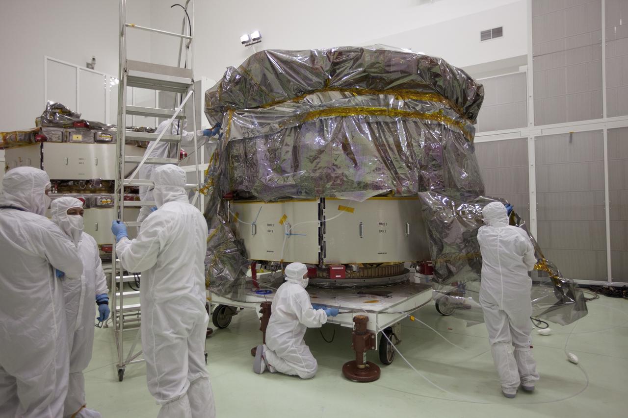 CAPE CANAVERAL, Fla. – The protective covering is removed from the two Magnetospheric Multiscale, or MMS, spacecraft comprising the mission’s upper stack in the Building 1 high bay of the Astrotech payload processing facility in Titusville, Florida, near Kennedy Space Center. The two MMS spacecraft comprising the lower stack arrived at Astrotech on Oct. 29. The Magnetospheric Multiscale mission is a Solar Terrestrial Probes mission comprising four identically instrumented spacecraft that will use Earth’s magnetosphere as a laboratory to study the microphysics of three fundamental plasma processes: magnetic reconnection, energetic particle acceleration and turbulence. Launch aboard a United Launch Alliance Atlas V rocket from Space Launch Complex 41 on Cape Canaveral Air Force Station is targeted for March 12, 2015. To learn more about MMS, visit http://mms.gsfc.nasa.gov.  Photo credit: NASA/Kim Shiflett