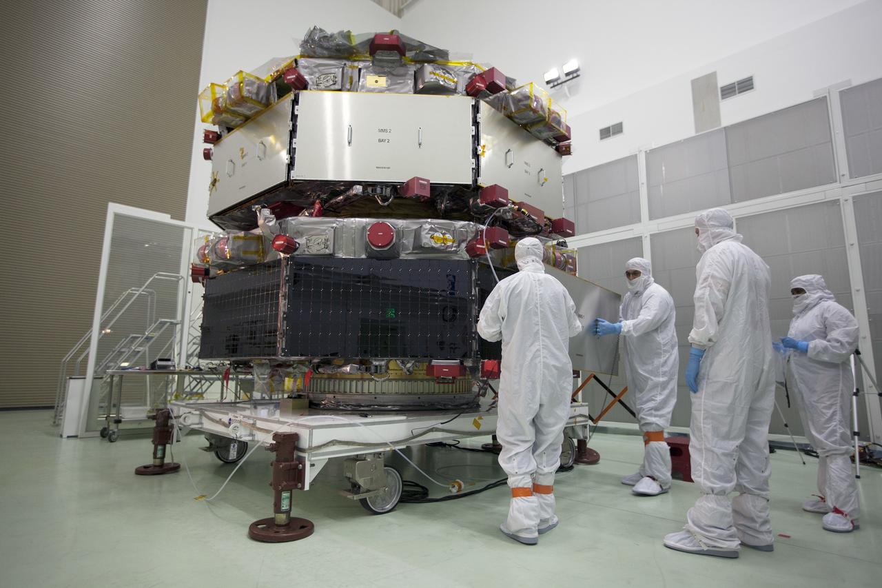 CAPE CANAVERAL, Fla. – Workers inspect the solar arrays on the Magnetospheric Multiscale, or MMS, observatories in the Building 1 D high bay of the Astrotech payload processing facility in Titusville, Florida, near Kennedy Space Center. The two MMS spacecraft comprising the upper deck arrived Nov. 12; the two comprising the lower stack arrived Oct. 29. MMS, led by a team from NASA's Goddard Space Flight Center, is a Solar Terrestrial Probes mission consisting of four identically instrumented spacecraft that will use Earth’s magnetosphere as a laboratory to study the microphysics of three fundamental plasma processes: magnetic reconnection, energetic particle acceleration and turbulence. Launch aboard a United Launch Alliance Atlas V rocket from Space Launch Complex 41 on Cape Canaveral Air Force Station is targeted for March 12, 2015. To learn more about MMS, visit http://mms.gsfc.nasa.gov.  Photo credit: NASA/Kim Shiflett