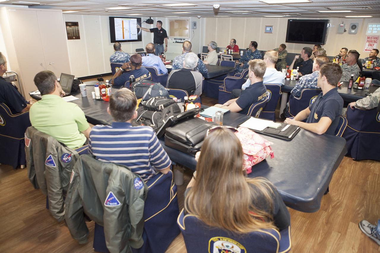 SAN DIEGO, Calif. – NASA Orion Recovery Director Jeremy Graeber, with the Ground Systems Development and Operations Program at Kennedy Space Center in Florida, reviews Orion recovery procedures with NASA, Lockheed Martin and U.S. Navy personnel aboard the USS Anchorage at Naval Base San Diego in California. Before the launch of Orion on its first flight test atop a Delta IV Heavy rocket from Cape Canaveral Air Force Station in Florida, NASA, Lockheed Martin and the U.S. Navy personnel will head out to sea in the USS Anchorage and the USNS Salvor, a salvage ship, and wait for splashdown of the Orion crew module in the Pacific Ocean. The GSDO Program will lead the recovery efforts. Orion is the exploration spacecraft designed to carry astronauts to destinations not yet explored by humans, including an asteroid and Mars. It will have emergency abort capability, sustain the crew during space travel and provide safe re-entry from deep space return velocities. The first unpiloted flight test of Orion is scheduled to launch in December atop a United Launch Alliance Delta IV Heavy rocket and in 2018 on NASA’s Space Launch System rocket. For more information, visit http://www.nasa.gov/orion. Photo credit: NASA/Dimitri Gerondidakis