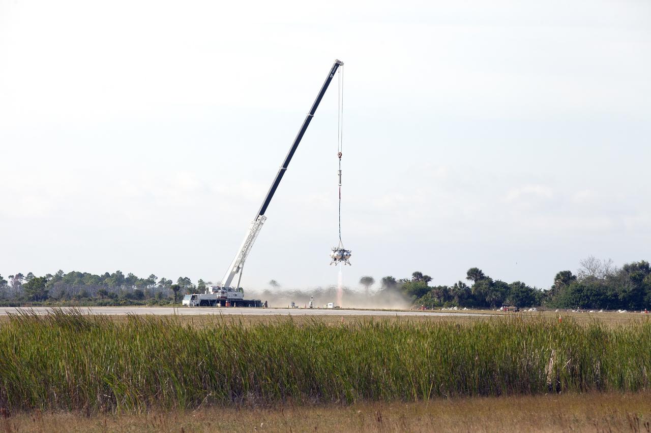 CAPE CANAVERAL, Fla. –NASA's Project Morpheus prototype lander's engine fires briefly in a tethered-flight test at the north end of the Shuttle Landing Facility at NASA’s Kennedy Space Center in Florida. However, the test was stopped following detection of an anomaly immediately after engine ignition. The tether test was cut short due to Morpheus exceeding onboard abort rate limits. The vehicle was taken back to the hangar and data from the test is being studied. After review, managers will determine when a new test date will be set. The landing facility provides the lander with the kind of field necessary for realistic testing, complete with rocks, craters and hazards to avoid. Morpheus’ ALHAT payload allows it to navigate to clear landing sites amidst rocks, craters and other hazards during its descent. For more information on Project Morpheus, visit http://morpheuslander.jsc.nasa.gov/. Photo credit: NASA/Kim Shiflett