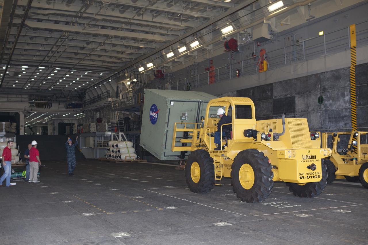 SAN DIEGO, Calif. – A forklift is used to carry ground support equipment into the well deck of the USS Anchorage at Naval Base San Diego in California. The equipment will be used during recovery of the Orion crew module after its first flight test. Before launch of Orion on a Delta IV Heavy rocket from Cape Canaveral Air Force Station in Florida, NASA, Lockheed Martin and U.S. Navy personnel will head out to sea in the USS Anchorage and the USNS Salvor, a salvage ship, and wait for splashdown of the Orion crew module in the Pacific Ocean. The Ground Systems Development and Operations Program will lead the recovery efforts. Orion is the exploration spacecraft designed to carry astronauts to destinations not yet explored by humans, including an asteroid and Mars. It will have emergency abort capability, sustain the crew during space travel and provide safe re-entry from deep space return velocities. The first unpiloted flight test of Orion is scheduled to launch in December atop a United Launch Alliance Delta IV Heavy rocket and in 2018 on NASA’s Space Launch System rocket. For more information, visit http://www.nasa.gov/orion. Photo credit: NASA/Dimitri Gerondidakis