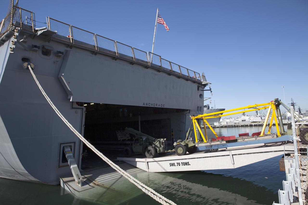SAN DIEGO, Calif. – Ground support equipment is being loaded into the well deck of the USS Anchorage at Naval Base San Diego in California. The equipment will be used during recovery of the Orion crew module after its first flight test. Before launch of Orion on a Delta IV Heavy rocket from Cape Canaveral Air Force Station in Florida, NASA, Lockheed Martin and U.S. Navy personnel will head out to sea in the USS Anchorage and the USNS Salvor, a salvage ship, and wait for splashdown of the Orion crew module in the Pacific Ocean.    The Ground Systems Development and Operations Program will lead the recovery efforts. Orion is the exploration spacecraft designed to carry astronauts to destinations not yet explored by humans, including an asteroid and Mars. It will have emergency abort capability, sustain the crew during space travel and provide safe re-entry from deep space return velocities. The first unpiloted flight test of Orion is scheduled to launch in December atop a United Launch Alliance Delta IV Heavy rocket and in 2018 on NASA’s Space Launch System rocket. For more information, visit http://www.nasa.gov/orion. Photo credit: NASA/Dimitri Gerondidakis