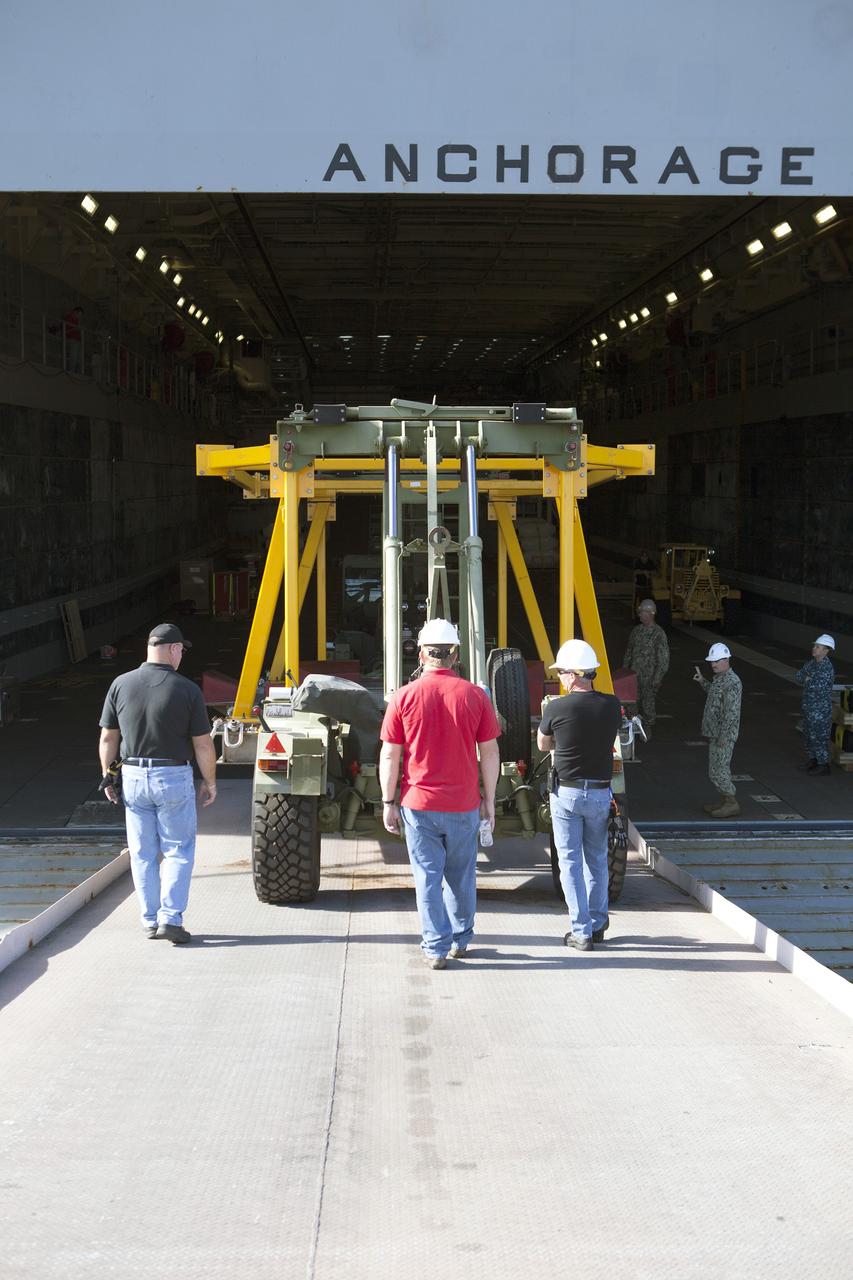 SAN DIEGO, Calif. – The Orion crew module recovery fixture is being loaded into the well deck of the USS Anchorage at Naval Base San Diego in California. The equipment will be used during recovery of the Orion crew module after its first flight test. Before launch of Orion on a Delta IV Heavy rocket from Cape Canaveral Air Force Station in Florida, NASA, Lockheed Martin and U.S. Navy personnel will head out to sea in the USS Anchorage and the USNS Salvor, a salvage ship, and wait for splashdown of the Orion crew module in the Pacific Ocean. The Ground Systems Development and Operations Program will lead the recovery efforts. Orion is the exploration spacecraft designed to carry astronauts to destinations not yet explored by humans, including an asteroid and Mars. It will have emergency abort capability, sustain the crew during space travel and provide safe re-entry from deep space return velocities. The first unpiloted flight test of Orion is scheduled to launch in December atop a United Launch Alliance Delta IV Heavy rocket and in 2018 on NASA’s Space Launch System rocket. For more information, visit http://www.nasa.gov/orion. Photo credit: NASA/Dimitri Gerondidakis