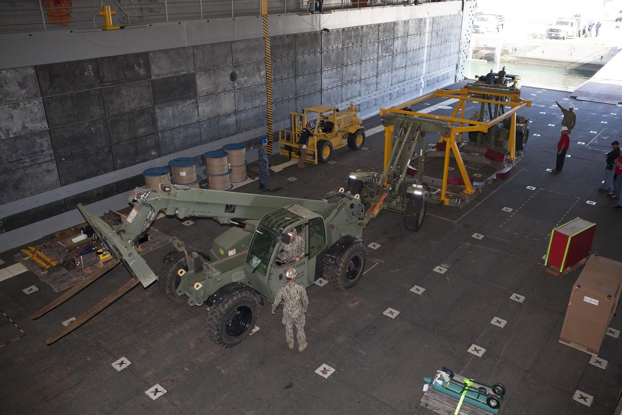 SAN DIEGO, Calif. – The Orion crew module recovery fixture is being loaded into the well deck of the USS Anchorage at Naval Base San Diego in California. The equipment will be used during recovery of the Orion crew module after its first flight test. Before launch of Orion on a Delta IV Heavy rocket from Cape Canaveral Air Force Station in Florida, NASA, Lockheed Martin and U.S. Navy personnel will head out to sea in the USS Anchorage and the USNS Salvor, a salvage ship, and wait for splashdown of the Orion crew module in the Pacific Ocean. The Ground Systems Development and Operations Program will lead the recovery efforts. Orion is the exploration spacecraft designed to carry astronauts to destinations not yet explored by humans, including an asteroid and Mars. It will have emergency abort capability, sustain the crew during space travel and provide safe re-entry from deep space return velocities. The first unpiloted flight test of Orion is scheduled to launch in December atop a United Launch Alliance Delta IV Heavy rocket and in 2018 on NASA’s Space Launch System rocket. For more information, visit http://www.nasa.gov/orion. Photo credit: NASA/Dimitri Gerondidakis