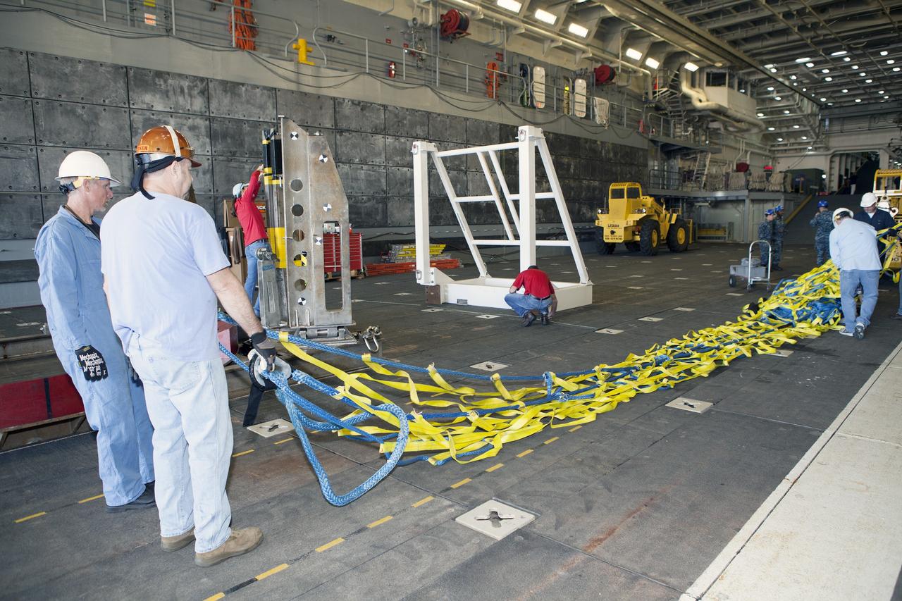 SAN DIEGO, Calif. – Ground support equipment is being secured in the well deck of the USS Anchorage at Naval Base San Diego in California. The equipment will be used during recovery of the Orion crew module after its first flight test. Before launch of Orion on a Delta IV Heavy rocket from Cape Canaveral Air Force Station in Florida, NASA, Lockheed Martin and U.S. Navy personnel will head out to sea in the USS Anchorage and the USNS Salvor, a salvage ship, and wait for splashdown of the Orion crew module in the Pacific Ocean.    The Ground Systems Development and Operations Program will lead the recovery efforts. Orion is the exploration spacecraft designed to carry astronauts to destinations not yet explored by humans, including an asteroid and Mars. It will have emergency abort capability, sustain the crew during space travel and provide safe re-entry from deep space return velocities. The first unpiloted flight test of Orion is scheduled to launch in December atop a United Launch Alliance Delta IV Heavy rocket and in 2018 on NASA’s Space Launch System rocket. For more information, visit http://www.nasa.gov/orion. Photo credit: NASA/Dimitri Gerondidakis