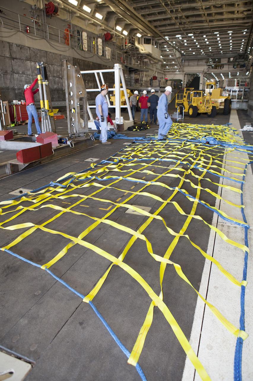 SAN DIEGO, Calif. – Ground support equipment is being secured in the well deck of the USS Anchorage at Naval Base San Diego in California. The equipment will be used during recovery of the Orion crew module after its first flight test. Before launch of Orion on a Delta IV Heavy rocket from Cape Canaveral Air Force Station in Florida, NASA, Lockheed Martin and U.S. Navy personnel will head out to sea in the USS Anchorage and the USNS Salvor, a salvage ship, and wait for splashdown of the Orion crew module in the Pacific Ocean. The Ground Systems Development and Operations Program will lead the recovery efforts. Orion is the exploration spacecraft designed to carry astronauts to destinations not yet explored by humans, including an asteroid and Mars. It will have emergency abort capability, sustain the crew during space travel and provide safe re-entry from deep space return velocities. The first unpiloted flight test of Orion is scheduled to launch in December atop a United Launch Alliance Delta IV Heavy rocket and in 2018 on NASA’s Space Launch System rocket. For more information, visit http://www.nasa.gov/orion. Photo credit: NASA/Dimitri Gerondidakis